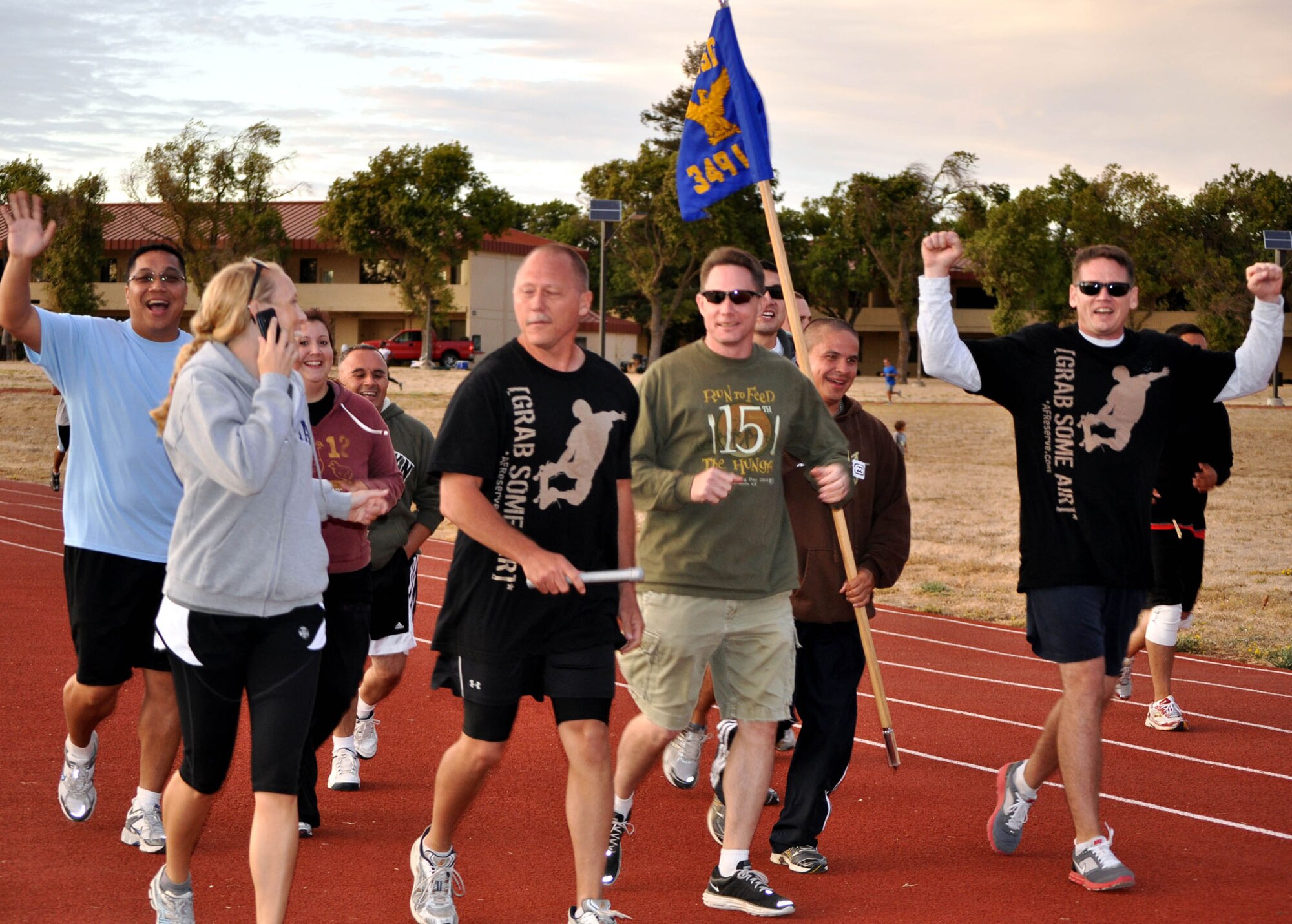 TRAVIS AIR FORCE BASE, Calif. -- The 349th Logistics Readiness Squadron team celebrates after completing the Viking Challenge 12-hour relay Oct. 1. Thirty-six teams completed 2,768 miles to help raise money for the Travis Fisher House. Competitors participated from the 60th Air Mobility Wing, the 615th Contingency Response Wing, the 349th AMW, Beale Air Force Base and the local community. The Reserve LRS team completed 64 miles, and the 349th AMW wing staff team of seven completed 72 miles. (U.S. Air Force photo/Senior Master Sgt. Ellen L. Hatfield)