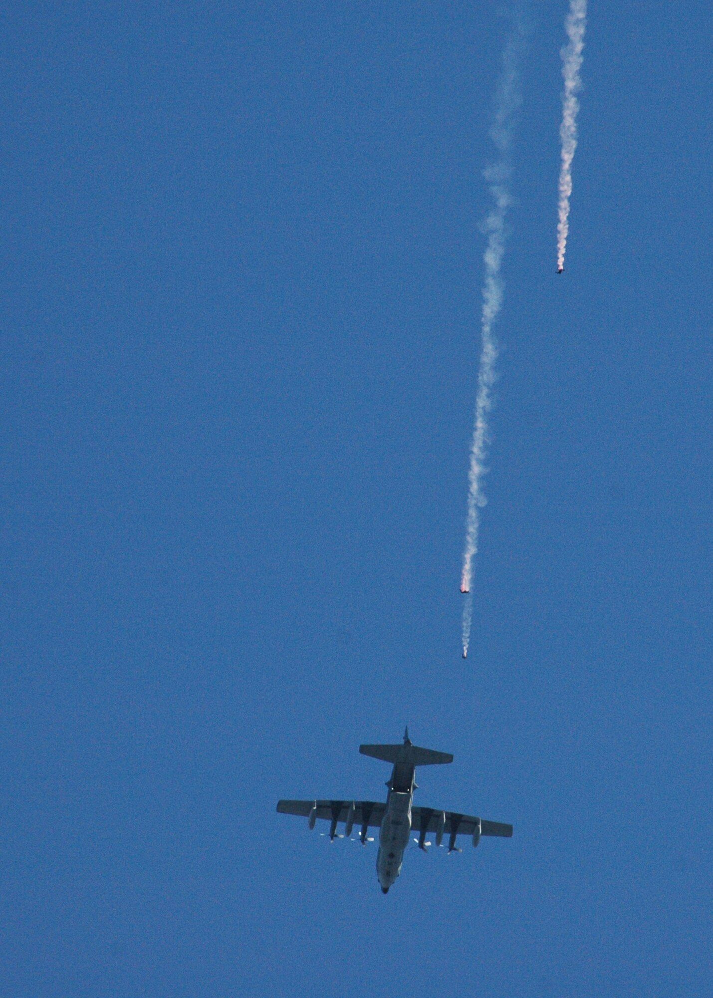 Jumping from an Air Force Reserve MC-130E aircraft from Duke Field, Fla., three members of the U.S. Army Special Operations Command's Black Daggers Parachute Demonstration Team streak earthward Oct. 14 during the 7th Special Forces Group (Airborne) open house at the unit's new compound on Eglin Air Force Base, Fla.  Better known as the 'Green Berets,' the elite Army special operations unit moved to Eglin from Fort Bragg, N.C. in response to 2005 Base Realignment and Closure legislation. (U.S. Air Force photo/Dan Neely)