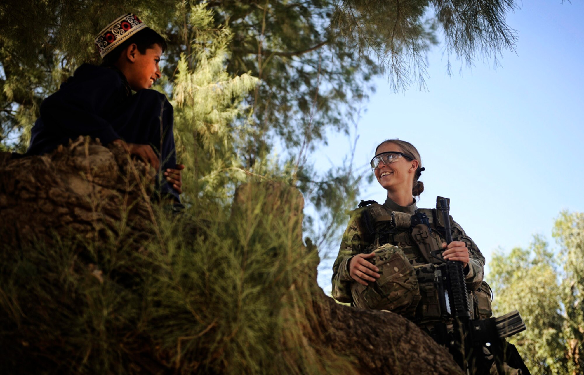 Senior Airman Lauren Everett talks to an Afghan child Oct. 14, 2011, during a patrol in Laghman province, Afghanistan. The PRT traveled to the village of Deh E Ziarat to meet with the village elder and the people. Everett is a medic assigned to the Laghman Provincial Reconstruction Team. (U.S. Air Force photo/Staff Sgt. Ryan Crane)  