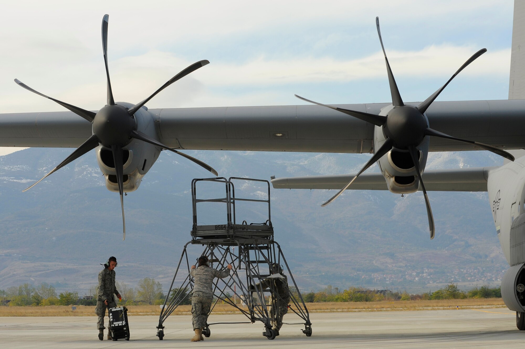 Airmen from the 86th Aircraft Maintenance Squadron at Ramstein Air Base, Germany, move an engine maintenance stand into position to work on a C-130J Super Hercules engine during Operation Thracian Fall 2011, Oct. 18, 2011 in Plovdiv, Bulgaria. OTF11 is an off-station training exercise designed to enhance interoperability between U.S. and Bulgarian Air Forces as well as build partnerships with paratroopers from both. (U.S. Air Force photo by Senior Airman Stephen J. Otero)