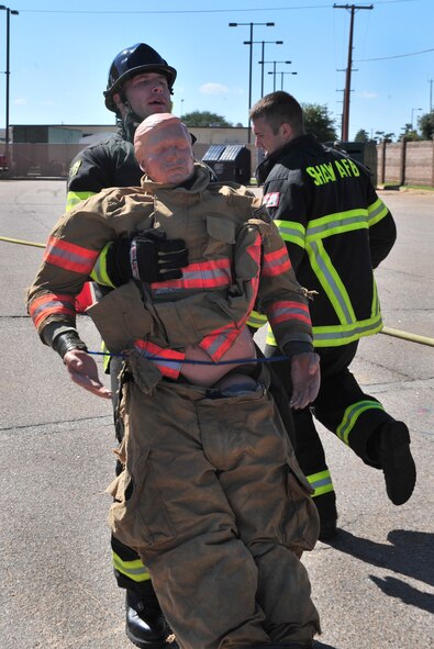 U.S. Air Force Staff Sgts. Chastin Warner and Stephen Thomas, 20th Civil Engineer Squadron firefighters, train for the Scott Firefighter Combat Challenge national relay in support of Fire Prevention Week at the Shaw Air Force Base, S.C. Oct. 14, 2011. The fire department held an open house for the Shaw community to learn about fire safety tips and prevention. Firefighters put on several demonstrations during the open house. (U.S. Air Force photo by Airman 1st Class Amber E. N. Jacobs/Released)
