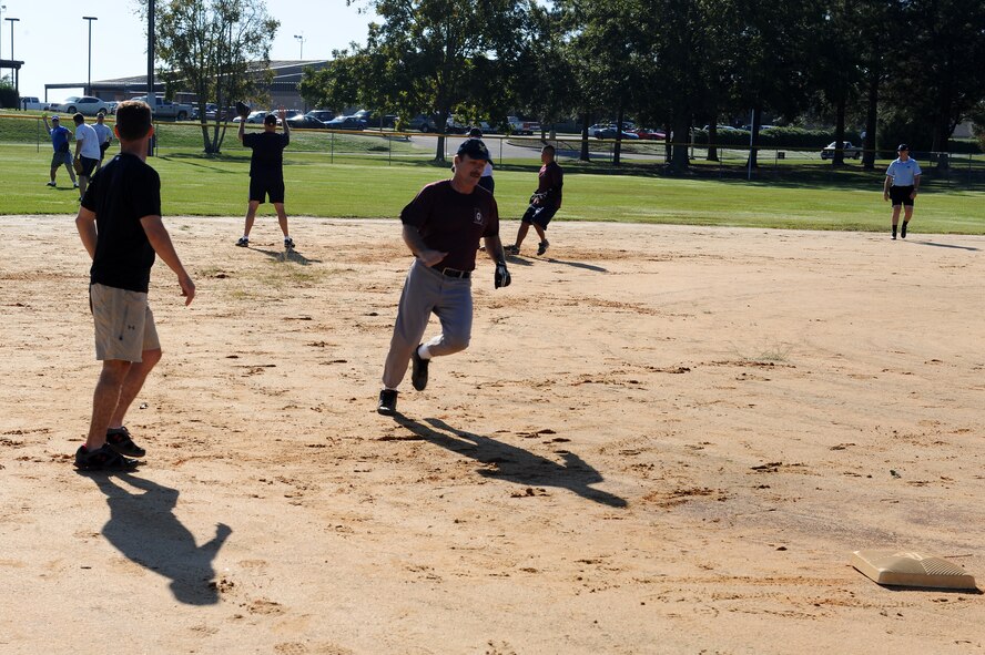 Darryl Gagne, 23rd Force Support Squadron, makes a run for third base during the Chiefs vs. Eagles Super Sports Day softball game at Moody Air Force Base, Ga., Oct. 14, 2011. Super Sports Day provided Airmen and families a chance to relax and come together to compete in sporting events. The Eagles defeated the Chiefs with a 15-9 win. (U.S. Air Force photo by Senior Airman Ciara Wymbs/Released)