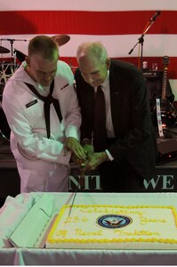 Seaman Andrew Jacobson and retired Navy Captain Bert Howard cut the cake celebrating the Navy's 236th birthday onboard the USS Yorktown at Patriots Point Naval and Maritime Museum, Oct. 14. In keeping with naval custom, the youngest and oldest Sailor at the ceremony receive the honor of cutting the birthday cake with a cutlass. Jacobson joined the Navy in June 2011; Howard joined in 1951 and retired in 1979. (U.S. Navy photo/Petty Officer 3rd Class Brannon Deugan)