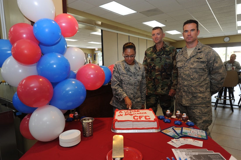 Master Sgt. Yvonne Espinosa, Joint Task Force-Bravo CFC coordinator, cuts a cake to celebrate the beginning of the Combined Federal Campaign with Lt. Col. Eric Moses, 612th ABS commander and Lt. Col. Christopher Buckley, JTF-Bravo chief of staff, Oct. 17, 2011, at Soto Cano Air Base, Honduras. (U.S. Air Force photo/Tech. Sgt Matthew McGovern)