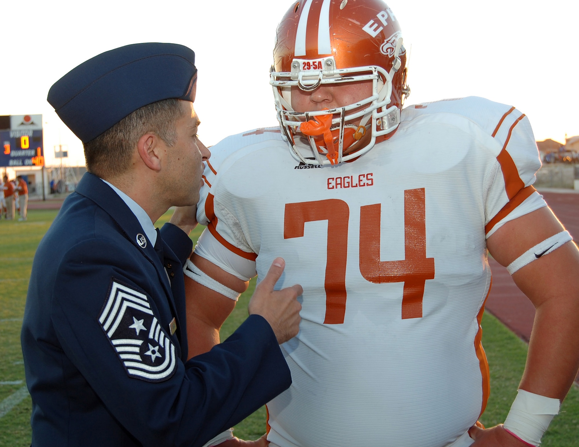 LAUGHLIN AIR FORCE BASE, Texas - Chief Master Ruben Gonzalez, Air Force Personnel Center command chief, speaks with Christian Garcia, Eagle Pass Eagles, Oct. 14 at the Walter Levermann Ram Stadium in Del Rio before the start of the game. The command chief was on hand to present a college scholarship sponsored by the Air Force. (U.S. Air Force photo/Master Sgt. Peter Borys)