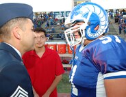 LAUGHLIN AIR FORCE BASE, Texas - Chief Master Sgt. Ruben Gonzalez, Air Force Personnel Center command chief, speaks with Federico Hernandez, Del Rio Rams, at the Walter Levermann Ram Stadium, Del Rio, Oct. 14. The command chief was on hand to present a college scholarship sponsored by the Air Force. (U.S. Air Force photo/Master Sgt. Peter Borys)