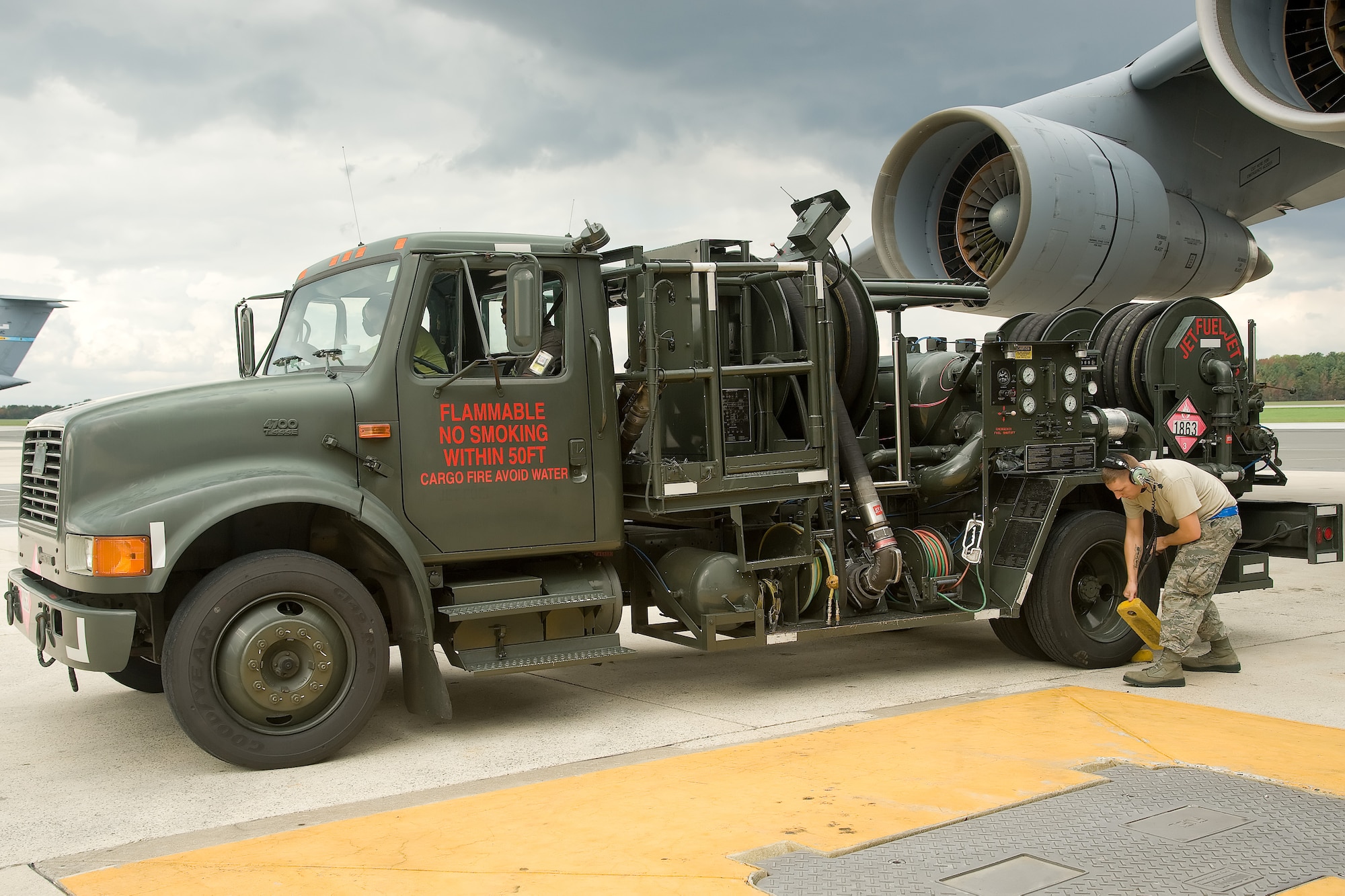 Staff Sgt. Joshua Piercy, a crew chief with the 436th Aircraft Maintenance Squadron, chocks off a refueling truck Oct. 14, 2011, at Dover Air Force Base, Del. Seven C-5s took off between Oct. 14 and Oct. 20 as part of a United States Transportation Command-wide 41-plane C-5 surge. (U.S. Air Force photo by Adrian Rowan)