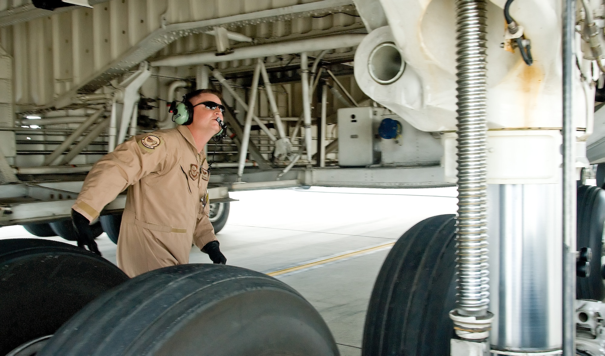 Master Sgt. David Moore, a flight engineer with the 9th Airlift Squadron, inspects a C-5 Galaxy before flight Oct. 14, 2011, at Dover Air Force Base, Del. Seven C-5s took off between Oct. 14 and Oct. 20 as part of a United States Transportation Command-wide 41-plane C-5 surge. (U.S. Air Force photo by Adrian Rowan)