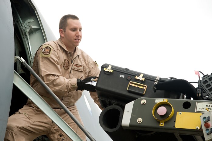Staff Sgt. Ryan Cordova, a loadmaster with the 9th Airlift Squadron, loads cargo into a C-5 Galaxy Oct. 14, 2011, at Dover Air Force Base, Del. Seven C-5s took off between Oct. 14 and Oct. 20 as part of a United States Transportation Command-wide 41-plane C-5 surge. (U.S. Air Force photo by Adrian Rowan)