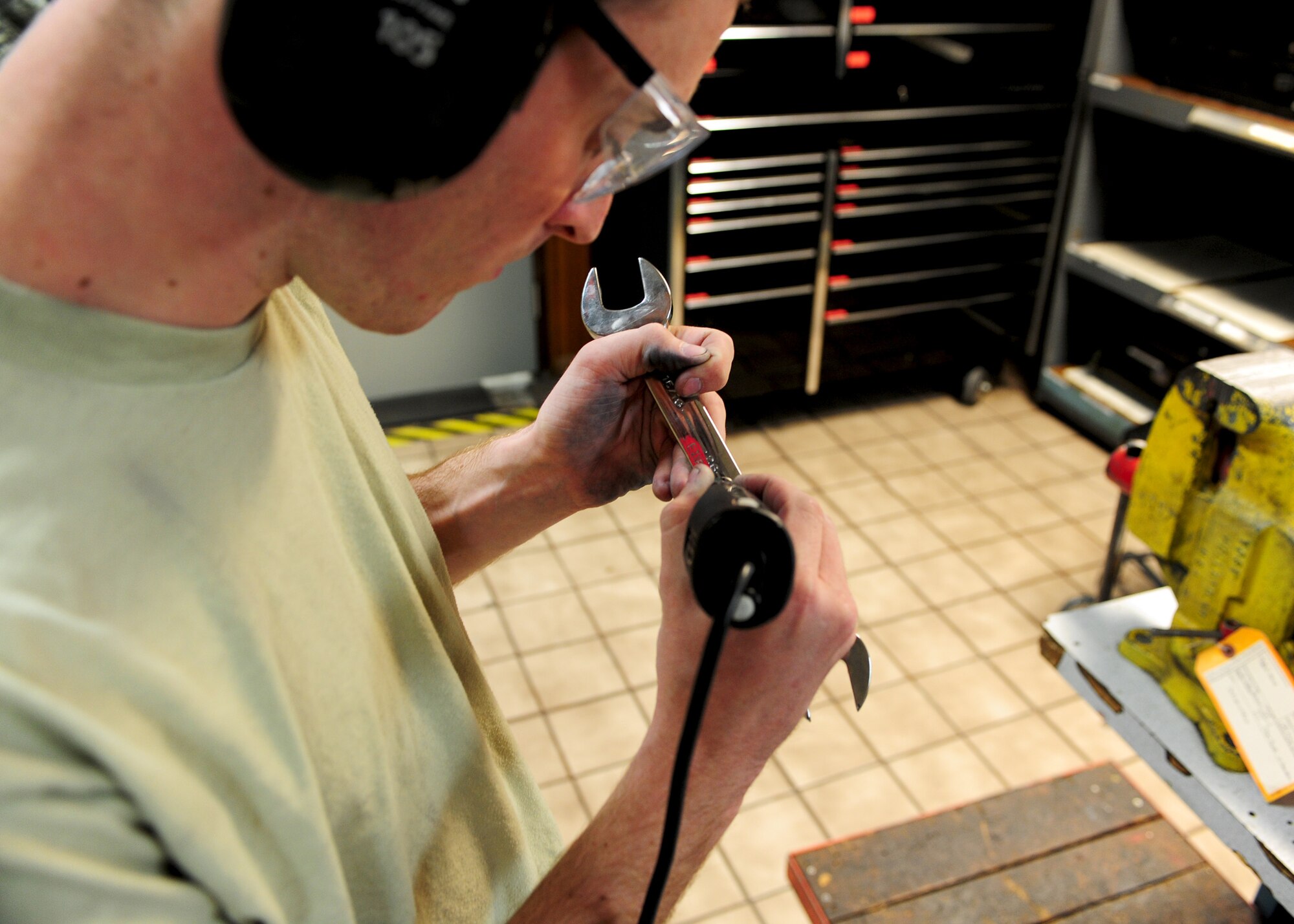 Airman 1st Class Tyler Sandberg, 28th Maintenance Squadron repair and reclamation journeyman, engraves a wrench with an etching tool on Ellsworth Air Force Base, S.D., Oct. 13, 2011. Sandberg was engraving every tool in each toolbox as a way of maintaining accountability for all tools in his shop and making it easier to locate and organize the tools. (U.S. Air Force photo by Airman Alystria Maurer/Released)