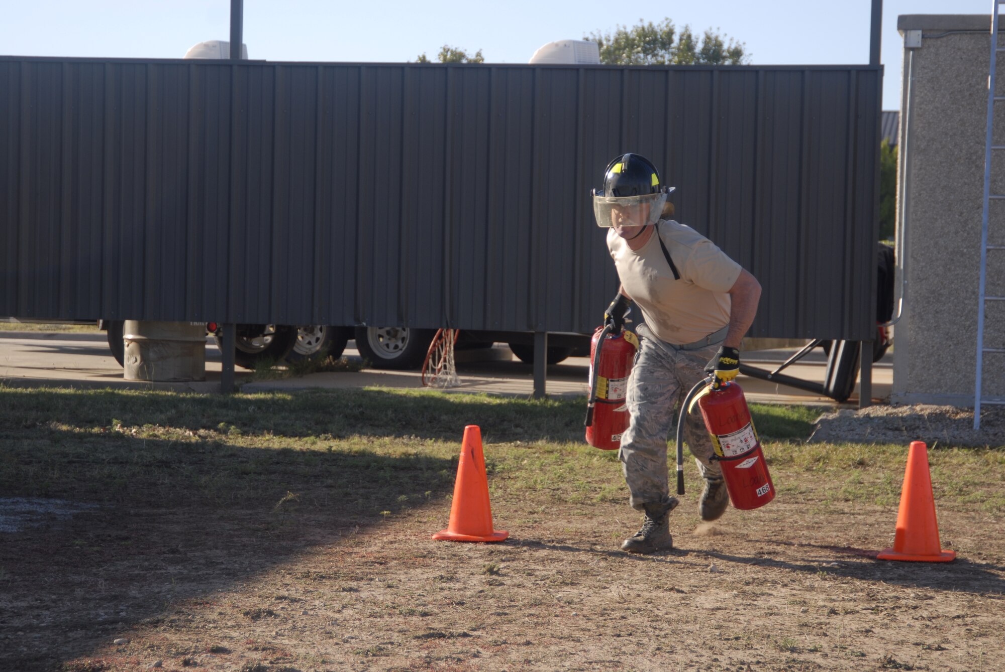 GOODFELLOW AIR FORCE BASE, Texas – Tech. Sgt. David Piskorick, 17th Security Forces Squadron, runs with fire extinguishers during a firefighter competition muster here Oct. 14. The fire department hosted the competition as part of the 89th National Fire Prevention Week, and to help raise awareness of fire safety. (U.S. Air Force photo /Senior Airman Heather L. Rodgers)