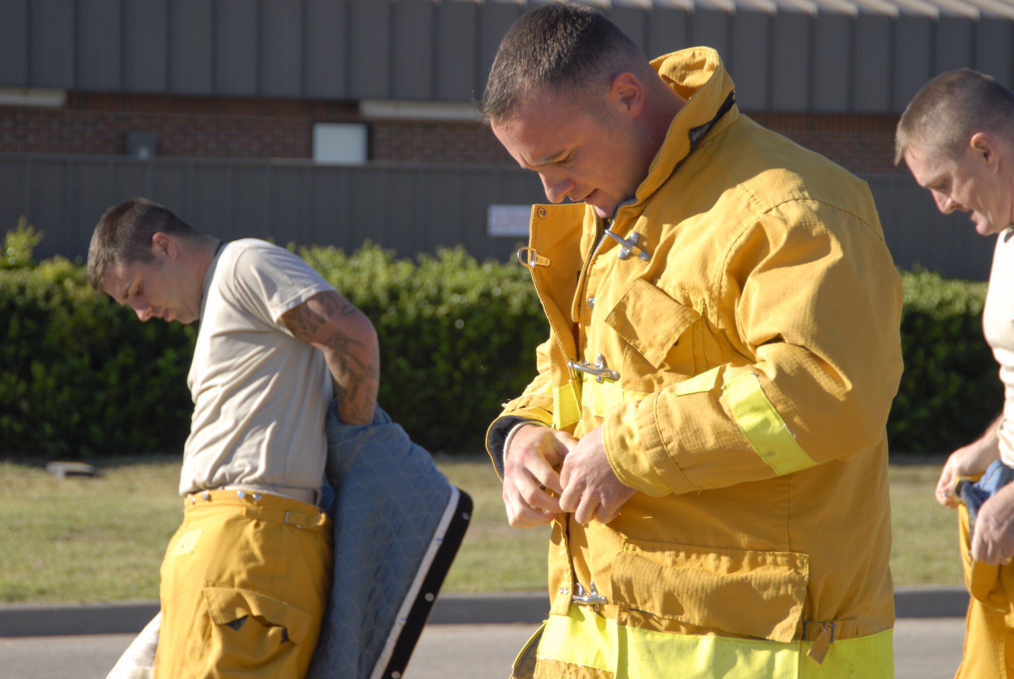 GOODFELLOW AIR FORCE BASE, Texas – Tech. Sgt. David Piskorick, 17th Security Forces Squadron, dons a fire fighting suit during a firefighter competition muster here Oct. 14. The fire department hosted the competition as part of the 89th National Fire Prevention Week, and to help raise awareness of fire safety. (U.S. Air Force photo /Senior Airman Heather L. Rodgers)