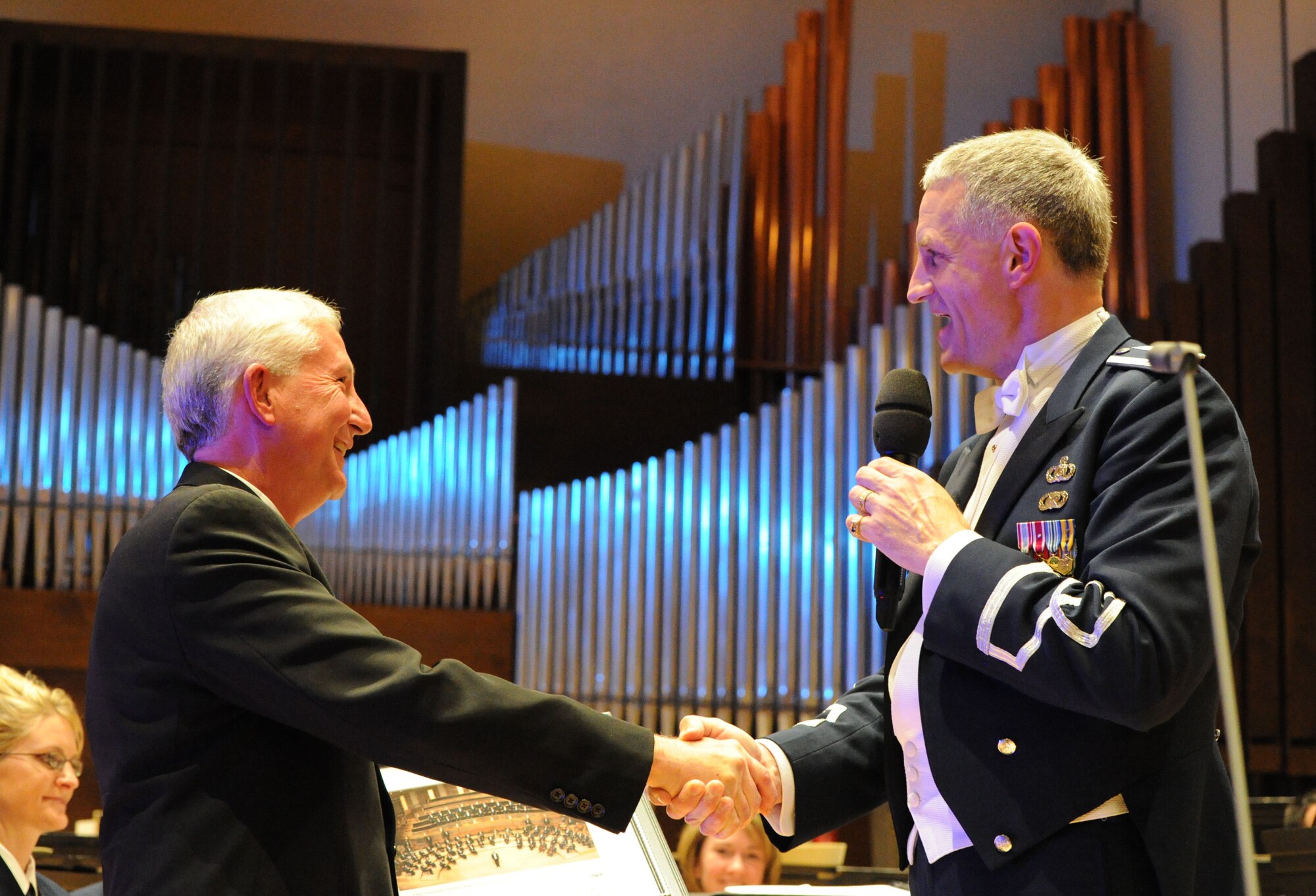 Col. A. Philip Waite, U.S. Air Force Band commander and conductor, presents Dr. Robert Belser, University of Wyoming Director of Bands, Laramie, Wy., an award of appreciation Oct. 17 for his contributions and assistance in bringing the concert band and singing sergeants to Wyoming. The USAF Band visited the university during the 2011 Fall Tour. (U.S. Air Force photo by Airman 1st Class Tabitha N. Haynes)