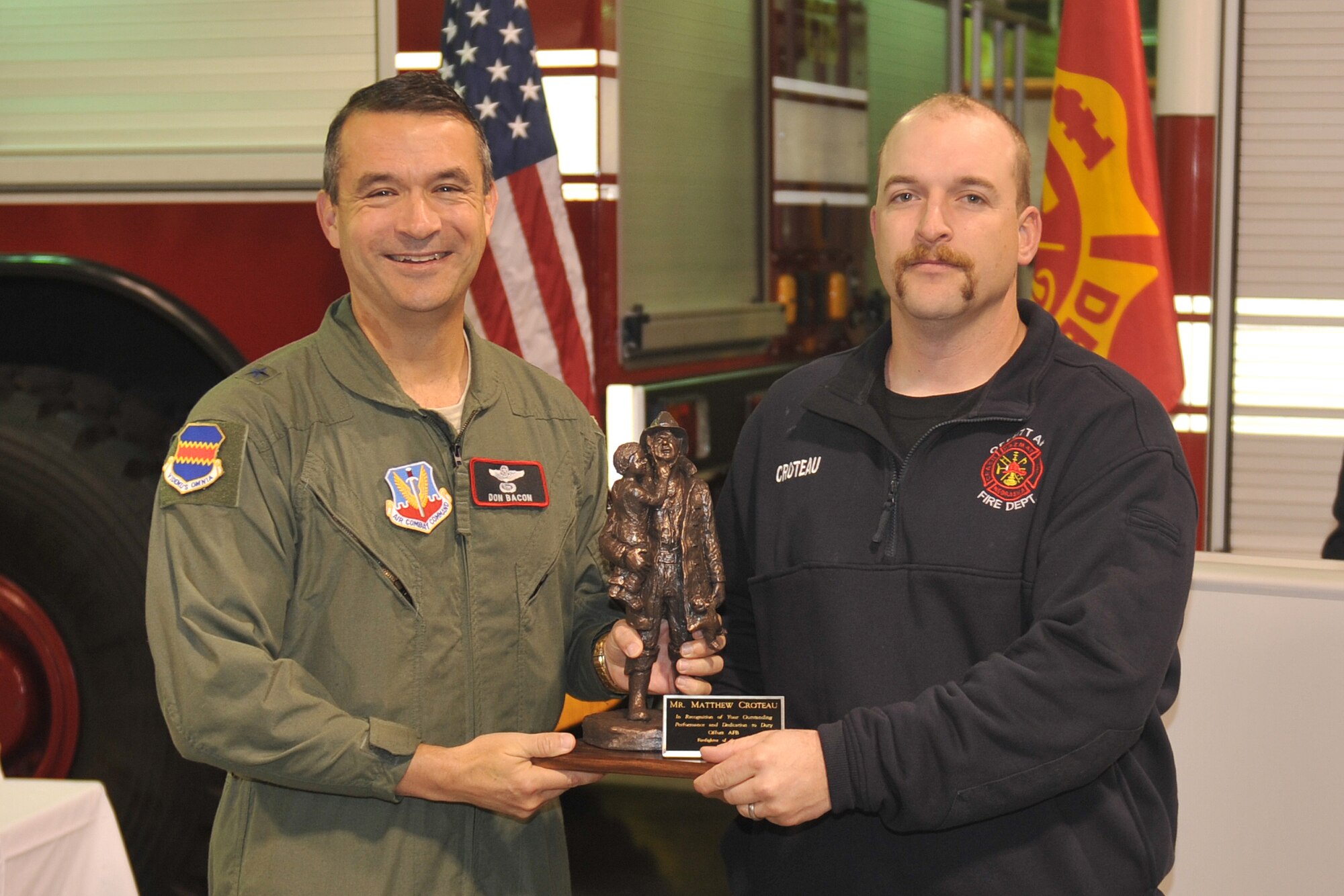 U.S. Air Force Brig. Gen. Donald J. Bacon, 55th Wing commander, presents the 2011 firefighter of the year award to Matthew Croteau at the Offutt Fire Station on Oct. 14. The award is given out annually during Fire Prevention Week. (U.S. Air Force photo by Jeff W. Gates/Released)