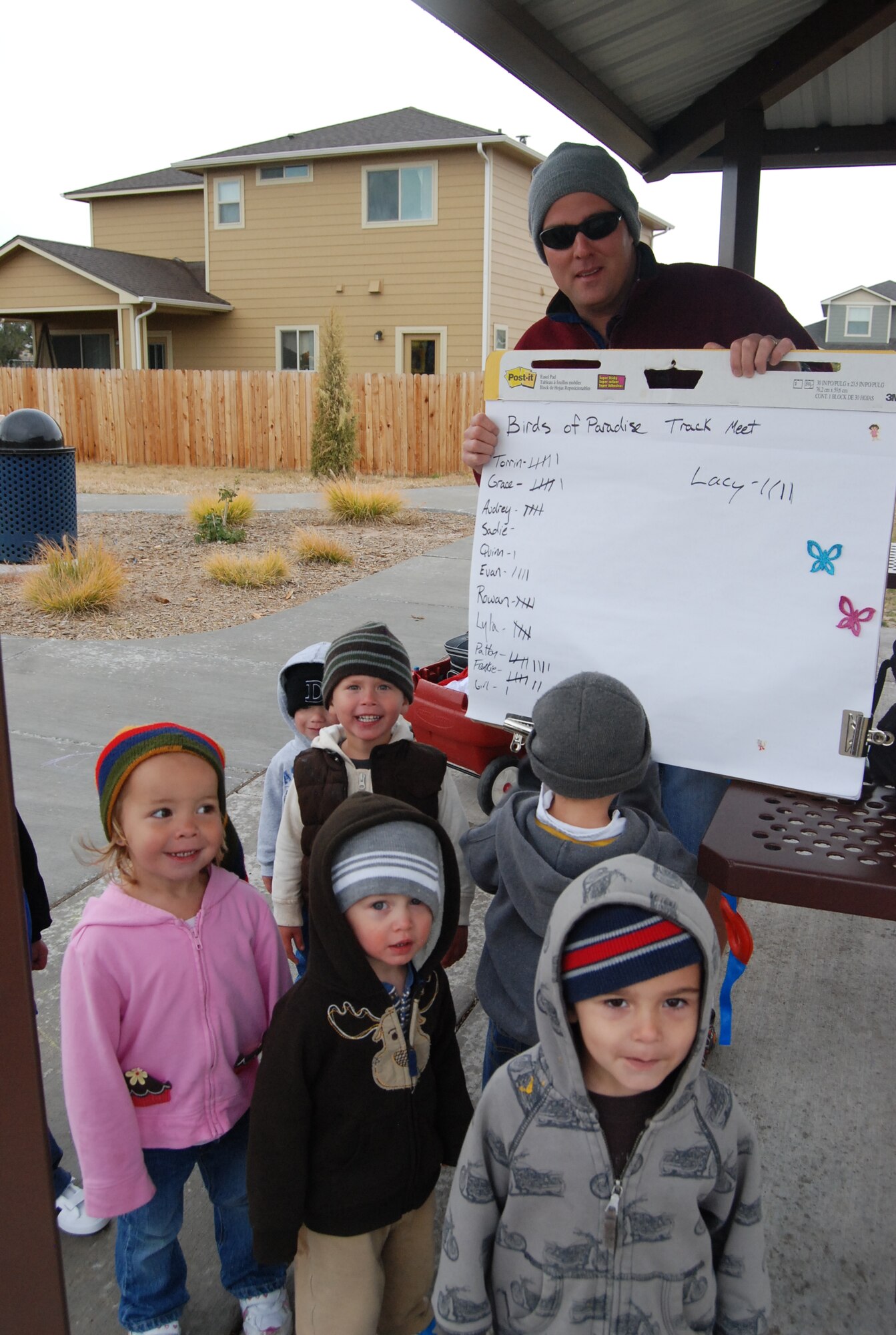Duane Cook, Family Child Care provider, helps his kids keep track of how many laps they’ve ran around the park during the Birds of Paradise track meet. After each lap, the kids received a small prize or snack. Peterson Air Force Base averages 12 FCC providers who watch up to six kids each. Providers have the freedom to be as creative with their activities as they want to be. The next FCC training starts Dec. 7. (U.S. Air Force photo/Lea Johnson)