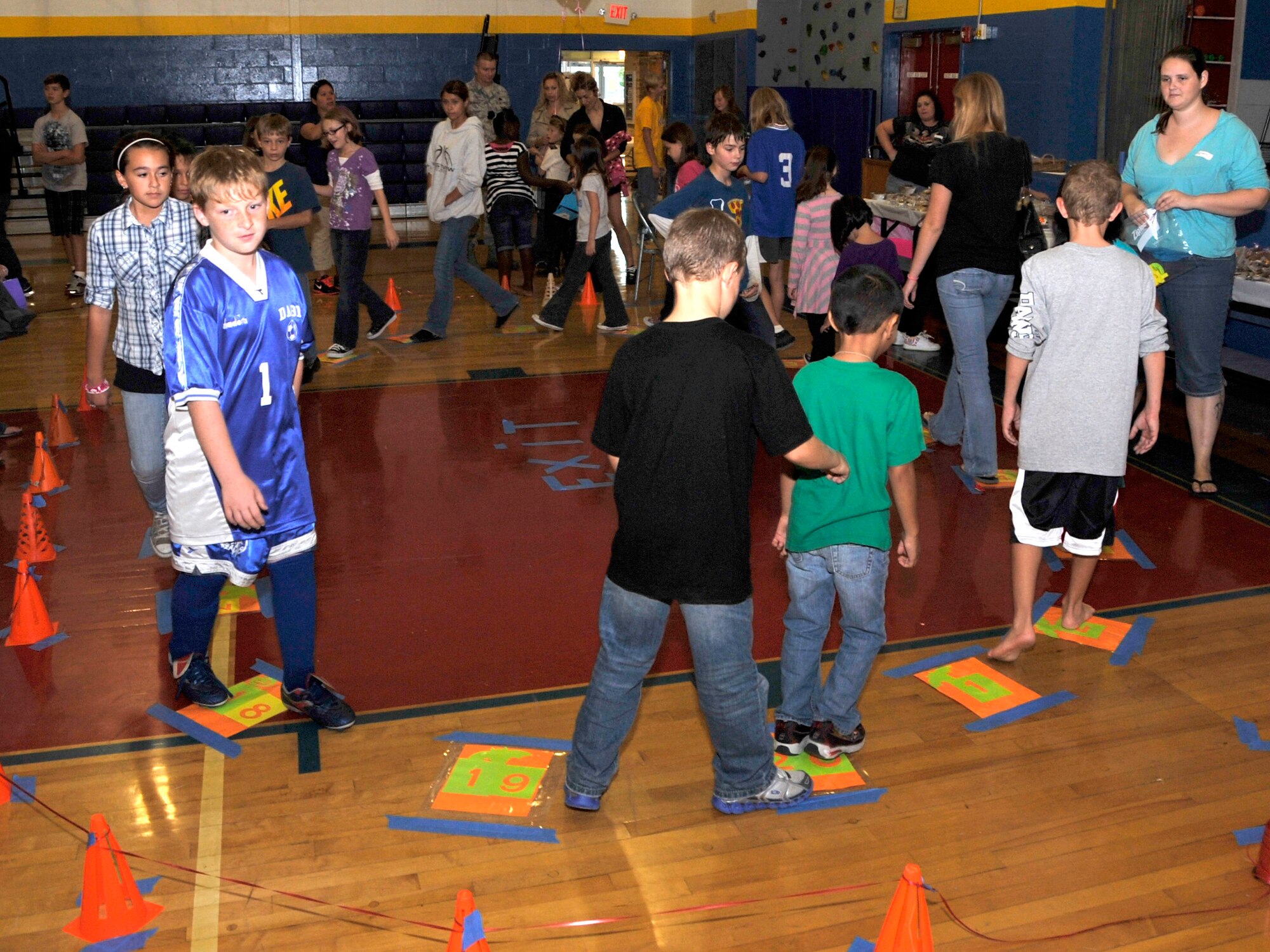 Children participate in a cake walk at the Major George S. Welch Elementary School Fall Festival Oct. 14, 2011, at Dover Air Force Base, Del. The event was hosted by the elementary school and the Dover AFB middle school. (U.S. Air Force photo by Tech. Sgt. Chuck Walker)