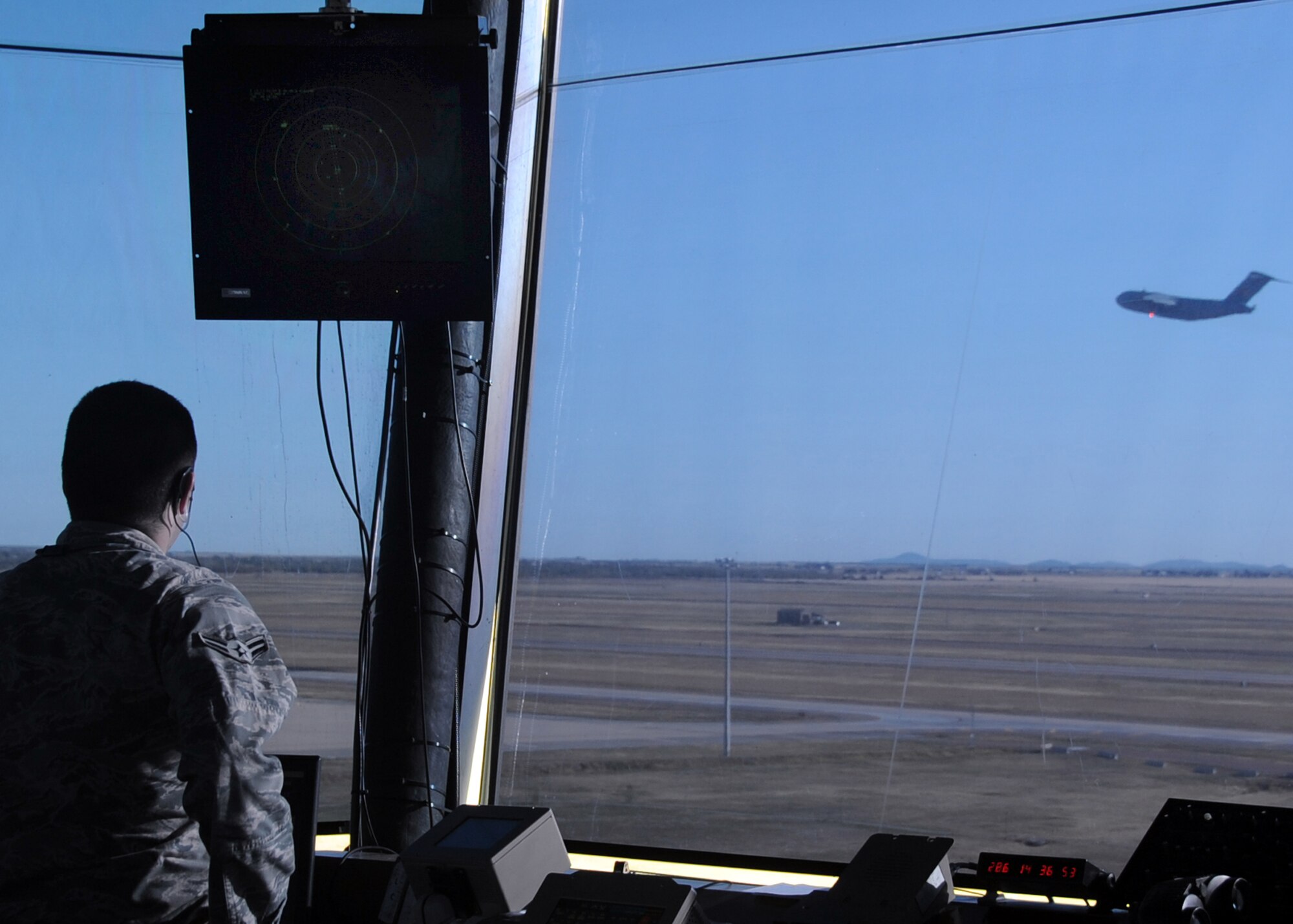 ALTUS AIR FORCE BASE, Okla. – Airman 1st Class Casey J. Noone, 97th Operations Support Squadron air traffic control apprentice, watches from the air traffic control tower as a C-17 Globemaster III takes off Oct. 13, 2011. Noone was working the local control traffic position in the tower and testing to earn his 5- skill level, while his supervisor listened to his communications with pilots and other personnel and graded him. (U.S. Air Force photo by Airman 1st Class Kenneth W. Norman / Released / 97th Air Mobility Wing Public Affairs) 