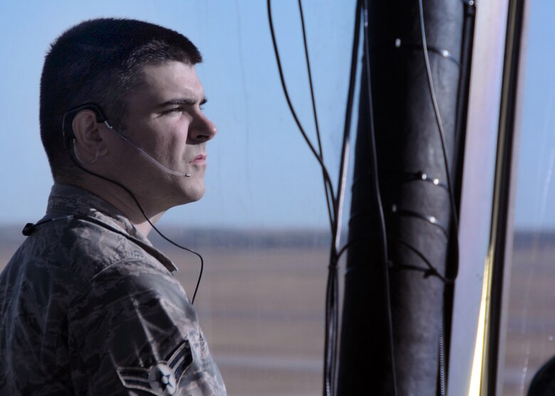 ALTUS AIR FORCE BASE, Okla. – Airman 1st Class Casey J. Noone, 97th Operations Support Squadron air traffic control apprentice, watches the airfield from the air traffic control tower Oct. 13, 2011. Noone was working the local control traffic position in the tower and testing to earn his 5-skill level, while his supervisor listened to his communications with pilots and other personnel and graded him. (U.S. Air Force photo by Airman 1st Class Kenneth W. Norman / Released / 97th Air Mobility Wing Public Affairs) 
