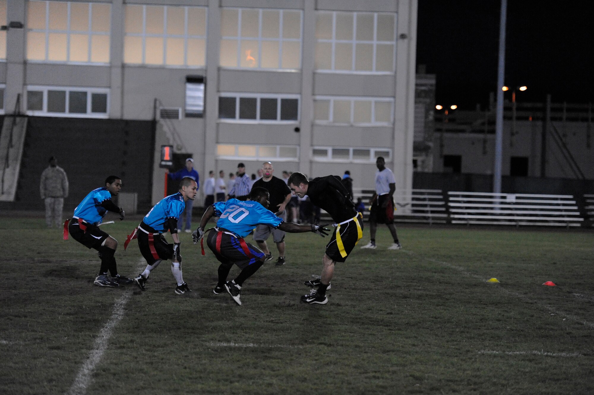Staff Sgt. Greg Hobbs, Team Triad, reaches for a flag on Airman 1st Class Jacob Plumb, 86th Security Forces, during the flag football championship game, Vogelweh track field, Vogelweh Military Complex, Oct. 14, 2011.  Team Triad won 21 games straight seizing an undefeated title for the season and closed it with one more win against SFS 21-0. (U.S. Air Force Photo by Staff Sgt. Gordon Hicks)