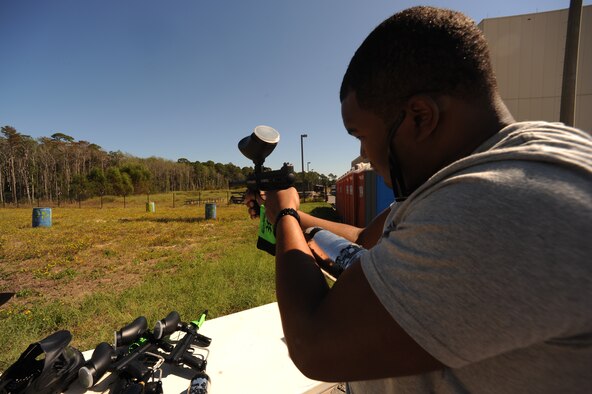 Senior Airman Billy Reams, 1st Special Operations Equipment Maintenance Squadron, aims for the pumpkin bulls-eye at a paint ball booth during the Fall Festival at the Freedom Hangar, Hurlburt Field, Fla., Oct. 15, 2011. The 1st Special Operations Force Support Squadron used the paintball display to promote Paintball PT, a physical training program. (U.S. Air Force photo/Senior Airman Eboni Reams)