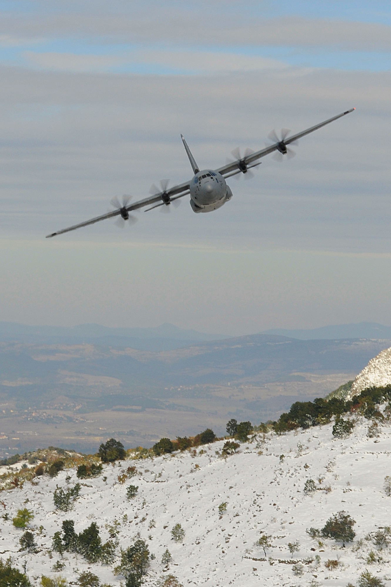 An Air Force C-130J Super Hercules assigned to the 37th Airlift Squadron, Ramstein Air Base, Germany, conducts low-level flight training during Operation Thracian Fall 2011, Oct. 18, 2011 in Plovdiv, Bulgaria. OTF11 is off-station training designed to enhance interoperability between U.S. and Bulgarian Air Forces as well as build partnerships with paratroopers from both. (U.S. Air Force photo by Senior Airman Stephen J. Otero)