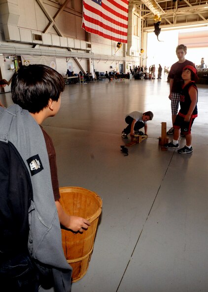 Children play a game trying to catapult a toy rat into a bin during the Fall Festival held at the Freedom Hangar, Hurlburt Field, Fla., Oct. 15, 2011. The festival provided 65 different activity, informational and concession booths for the more than 4,200 attendees’ enjoyment. (U.S. Air Force photo/Senior Airman Eboni Reams) 