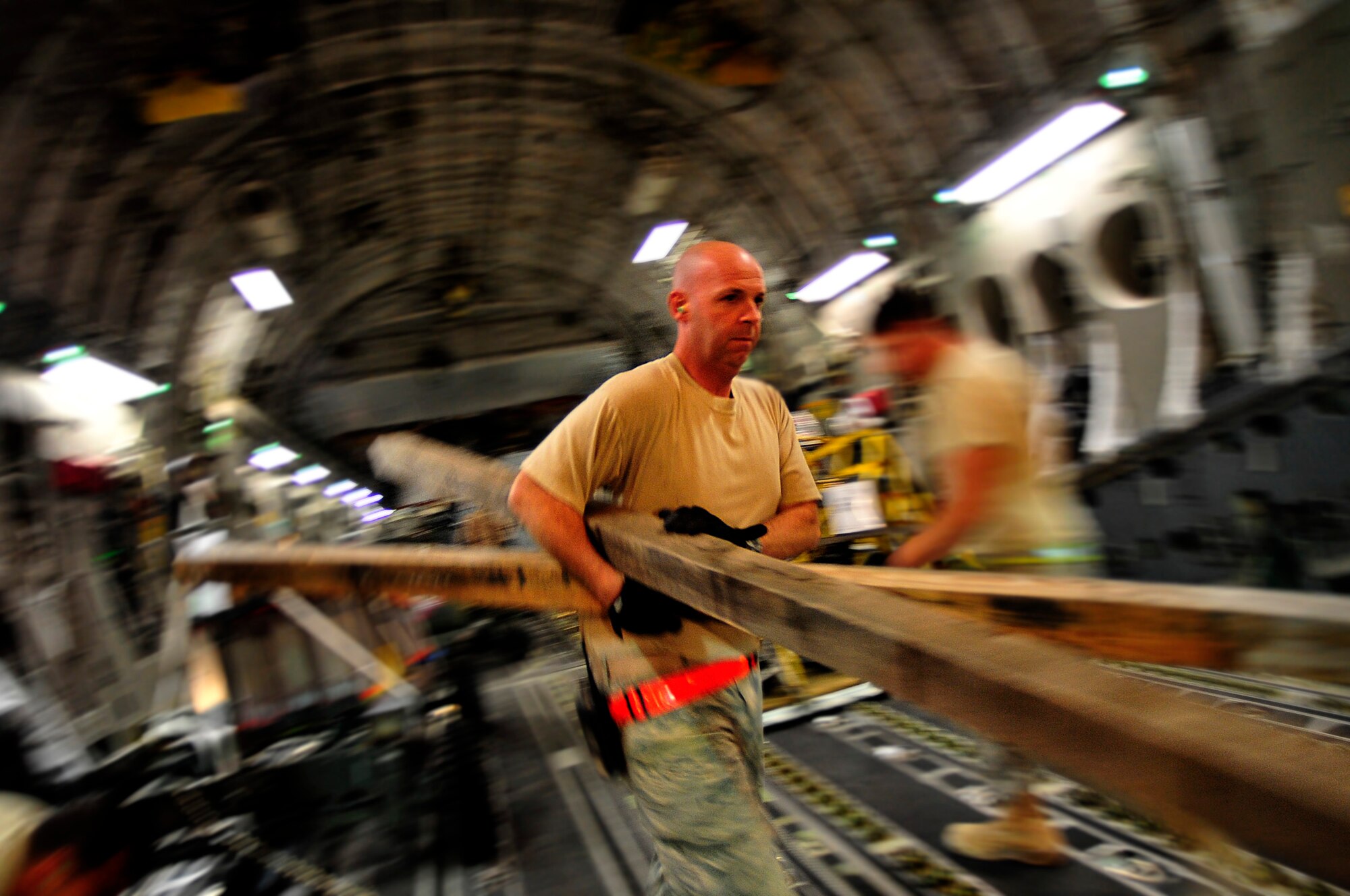 Staff Sgt. Tommy Sherrod, 532nd Expeditionary Operations Support Squadron aerial porter, offloads a C-17 Globemaster III in Iraq Oct. 1, 2011. Sherrod is deployed from Joint Base Pearl Harbor-Hickam, Hawaii, and is from Savannah, Ga. (U.S. Air Force photo/Master Sgt. Cecilio Ricardo)
