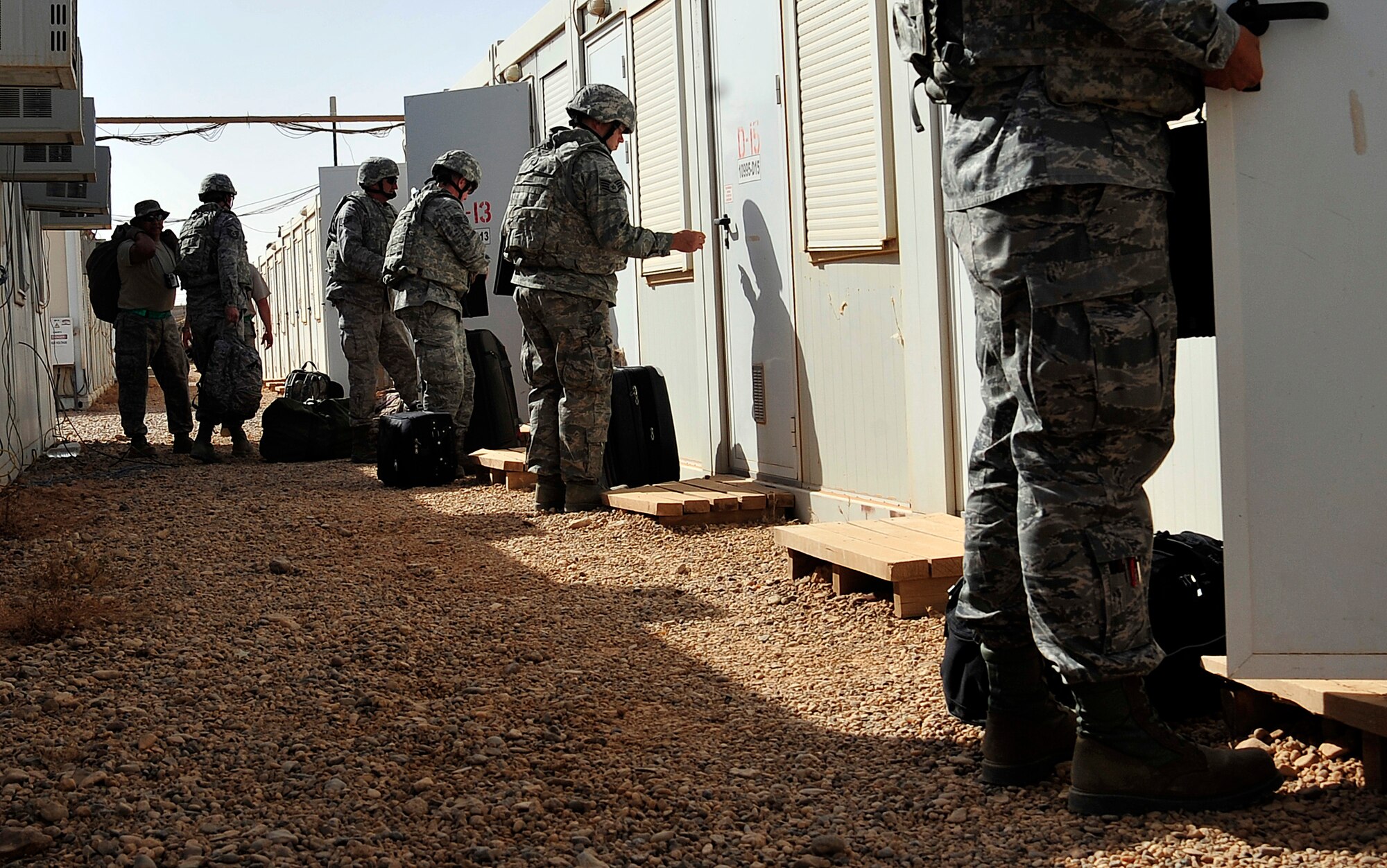Airmen from the 125th Expeditionary Fighter Squadron move into their living quarters after arriving in Iraq on Oct. 1, 2011. The squadron deployed in support of Operation New Dawn and will provide close air support for more than 40,000 troops leaving Iraq by the end of the year. The 125th EFS comprises F-16 Fighting Falcons, pilots, maintenance specialists and support personnel from the Oklahoma Air National Guard's 138th Fighter Wing in Tulsa, Okla., and the Ohio Air National Guard's 180th Fighter Wing in Toledo, Ohio. (U.S. Air Force photo/Master Sgt. Cecilio Ricardo)