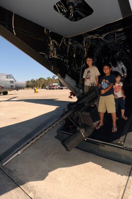 A family explores the inside of a CV-22 Osprey during the Fall Festival held at the Freedom Hangar, Hurlburt Field, Fla., Oct. 15, 2011. More than 4,200 people turned out during the event intended to give back to Air Commando families. ( U.S. Air Force photo/ Senior Airman Eboni Reams)