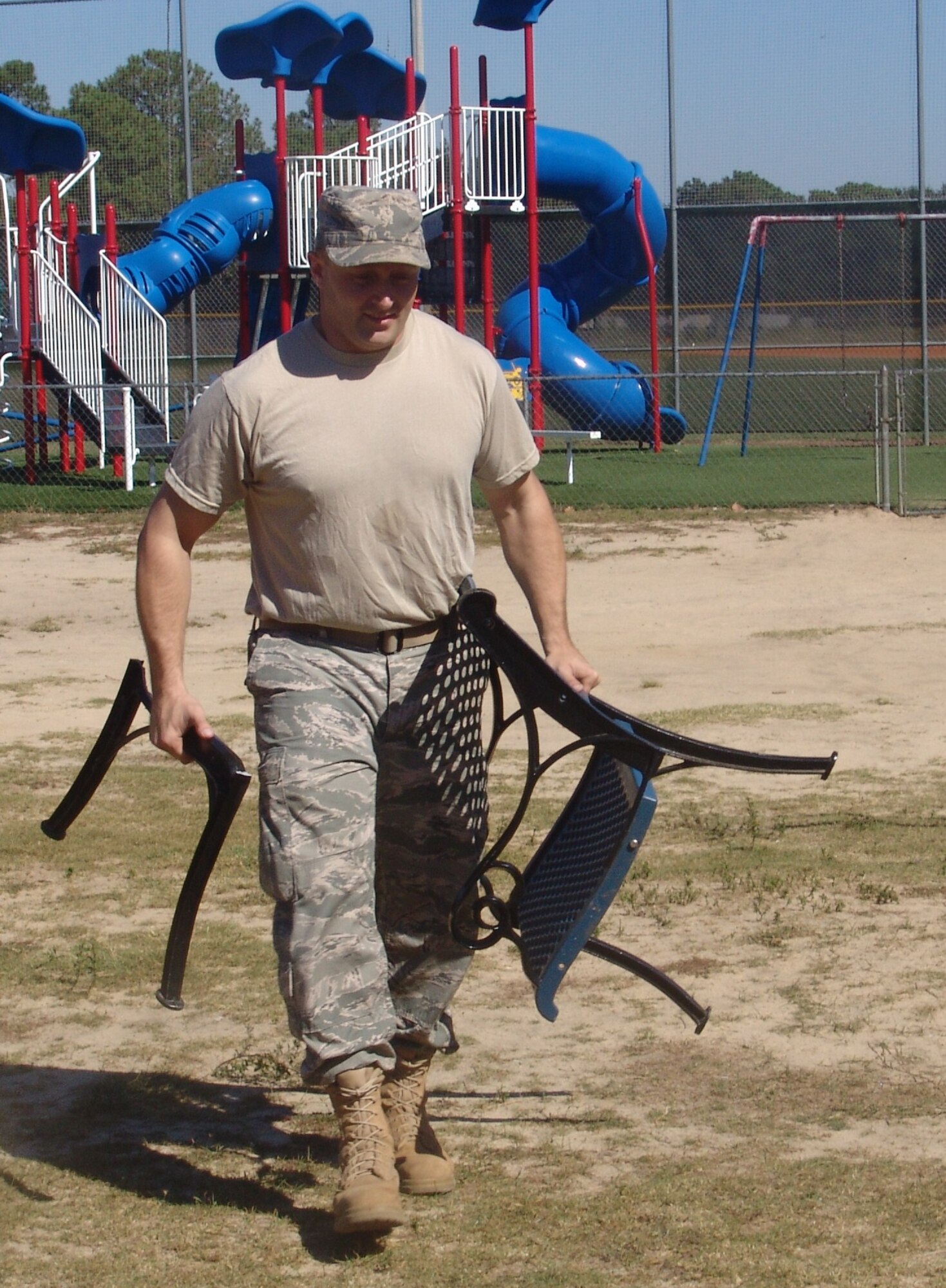 Staff Sgt. Scott Herbert removes broken furniture from a storage shed at the Boys and Girls Club.  Seven students from Naval School Explosive Ordnance Disposal spent their free day helping others. (USAF photo/Lois Walsh)