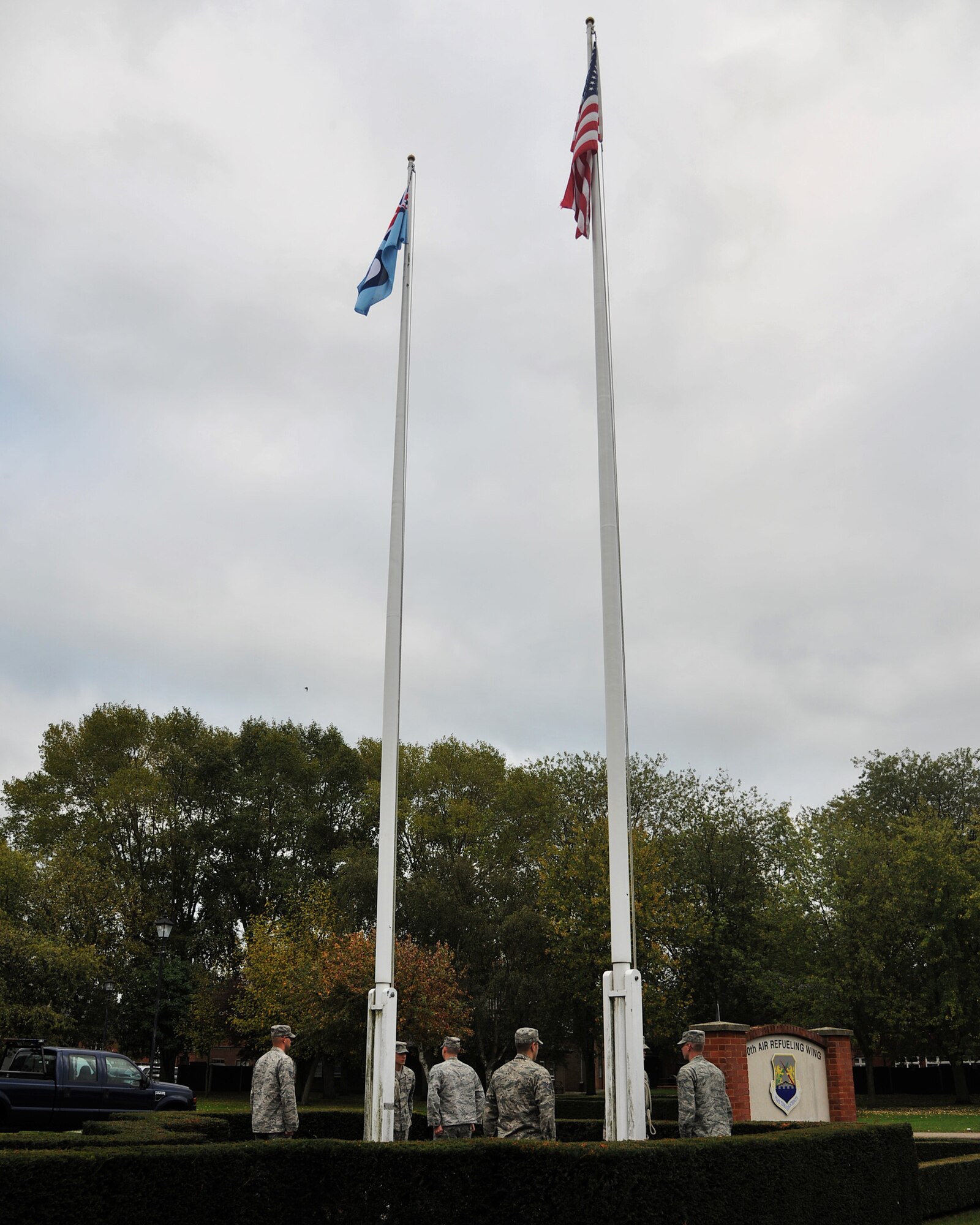 RAF MILDENHALL, England - Firefighters from the 100th Civil Engineer Squadron raise the flag from half-staff in honor of National Fallen Firefighter day here Oct. 16, 2011. According to the National Fallen Firefighters Foundation, 72 firefighters across the U.S. lost their lives in the line of duty last year. (U.S. Air Force photo/Senior Airman Jerilyn Quintanilla) 