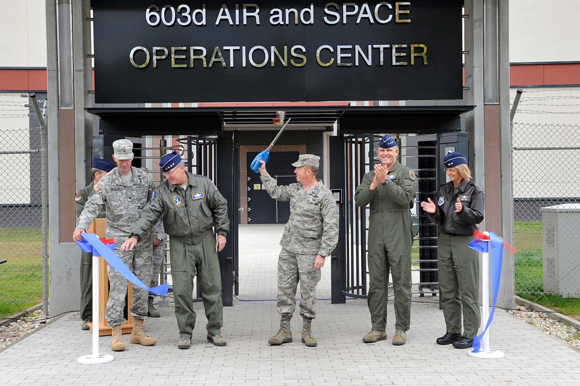 U.S. Army Col. D. Peter Hemlinger, commander of United States Army Corps of Engineers Europe, U.S. Air Force General Mark A. Welsh III, USAFE commander, Col. Peter F. Davey, 603rd AOC commander, Lt. Gen. Frank Gorenc, 3rd Air Force commander, and Maj. Gen. Margaret Woodward, 17th Air Force commander commemorate the opening of the 603rd Air and Space Operations Center (AOC), Ramstein Air Base, Germany, Oct. 7, 2011. The 603rd AOC is now responsible for U.S. air operations for European and Africa Commands areas of responsibility, to include 105 countries. Air Forces Africa (17th Air Force) is in the process of consolidating with 3rd Air Force and the USAFE staff. (U.S. Air Force photo by Staff Sgt. Tyrona Lawson)