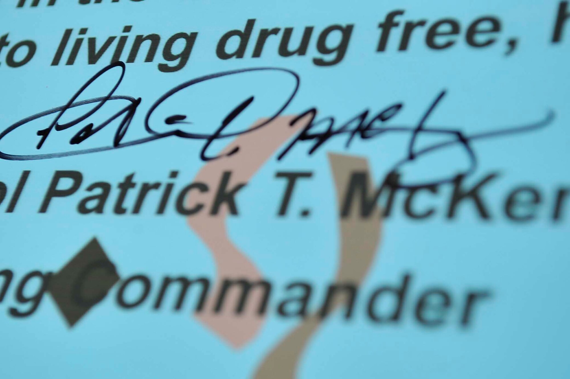 Col. Patrick McKenzie, 51st Fighter Wing commander, signature on the Red Ribbon Week proclamation Oct. 17, 2011. Red Ribbon Week is the nation's oldest and largest drug prevention program, reaching millions of Americans during the last week of October every year. The Defense Department's 2011 Red Ribbon Week observation is set for Oct. 23-31. Since 1990, DOD has officially participated in this event to raise public awareness and mobilize communities to combat tobacco, alcohol and drug use among military personnel, civilians and their families. (U.S. Air Force photo/Senior Airman Adam Grant)     
