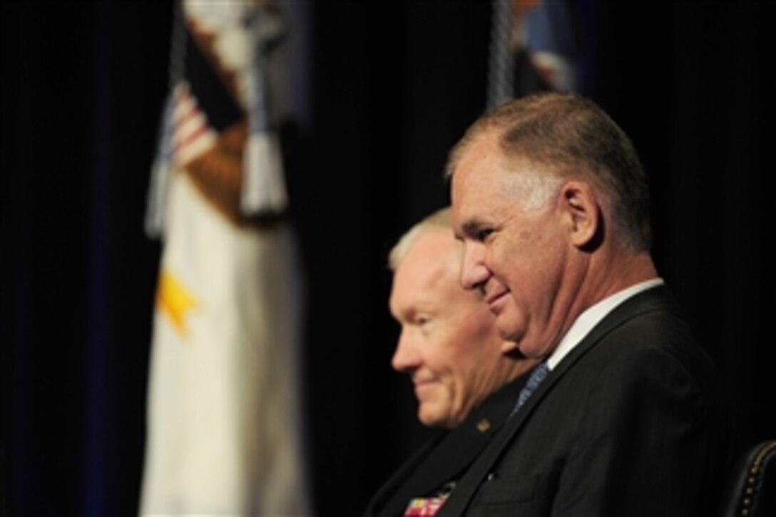 Former Deputy Secretary of Defense William J. Lynn III, right, and Chairman of the Joint Chiefs of Staff Gen. Martin Dempsey, U.S. Army, listen as Secretary of Defense Leon E. Panetta addresses the audience at a farewell ceremony in honor of Lynn in the Pentagon, in Arlington, Va., on Oct. 13, 2011.  