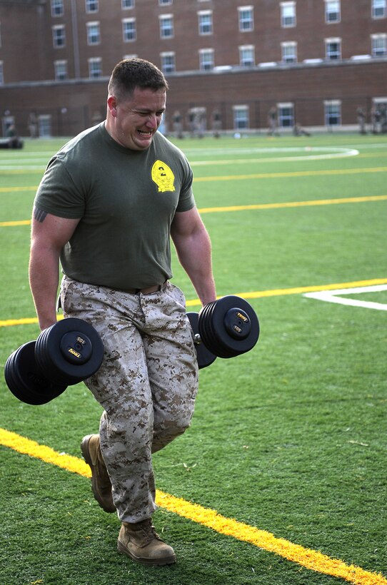 Sgt. Michael Ramsey, a body bearer, performs the timed farmer's walk in the third timed event of Musclefest at Marine Barracks Washington Oct. 18, 2011. For the farmer's walk, Marines had to carry two dumbbells that equaled their body weight for a total of 100 yards.