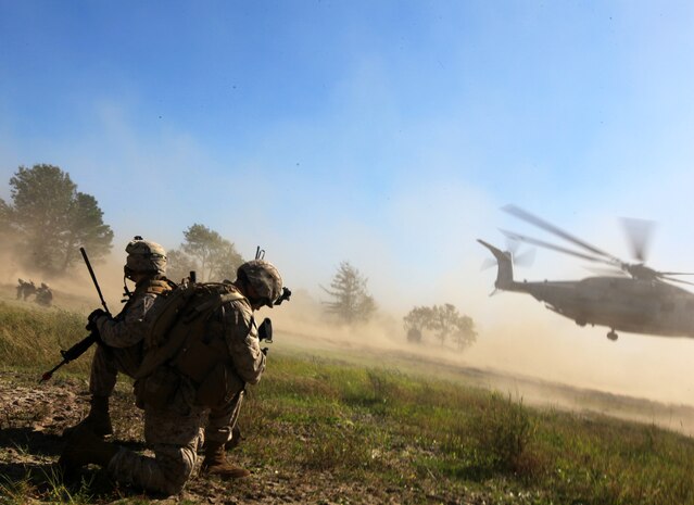 U.S. Marines with Bravo Company, 1st Battalion, 2nd Marine Regiment, secure a landing zone for a CH-53E Super Stallion during a practice raid as part of the Vertical Assault Course aboard Camp Lejeune, N.C., Oct. 18, 2011. The Vertical Assault Course took place Oct. 10-21 to provide Marines and Sailors of Bravo Co. familiarization with air operations for their upcoming deployment as part of the Battalion Landing Team for the 24th Marine Expeditionary Unit.