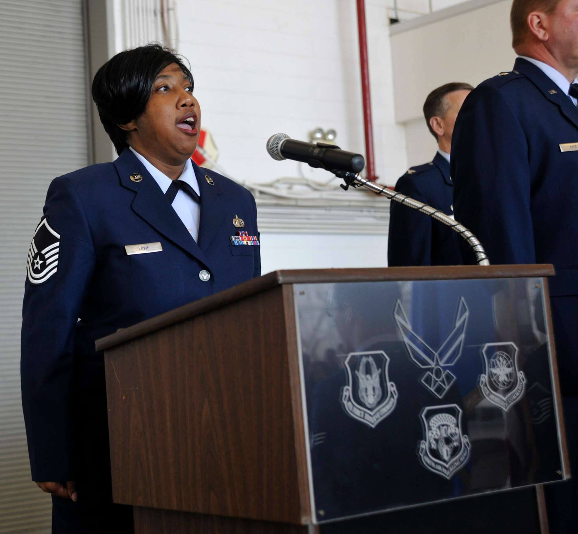 JOINT BASE ANDREWS, Md. -- Master Sgt. Charlene Lowe, 459th Air Refueling Wiing Force Support Squadron, sings the national anthem during a change of command ceremony here Oct. 15. Leadership of the 459th ARW has been passed to Col. Samuel Mahaney, who comes to the wing from an operations group commander position at Westover Air Reserve Base, Mass. (U.S. Air Force photo/Airman First Class Lindsey Beadle)