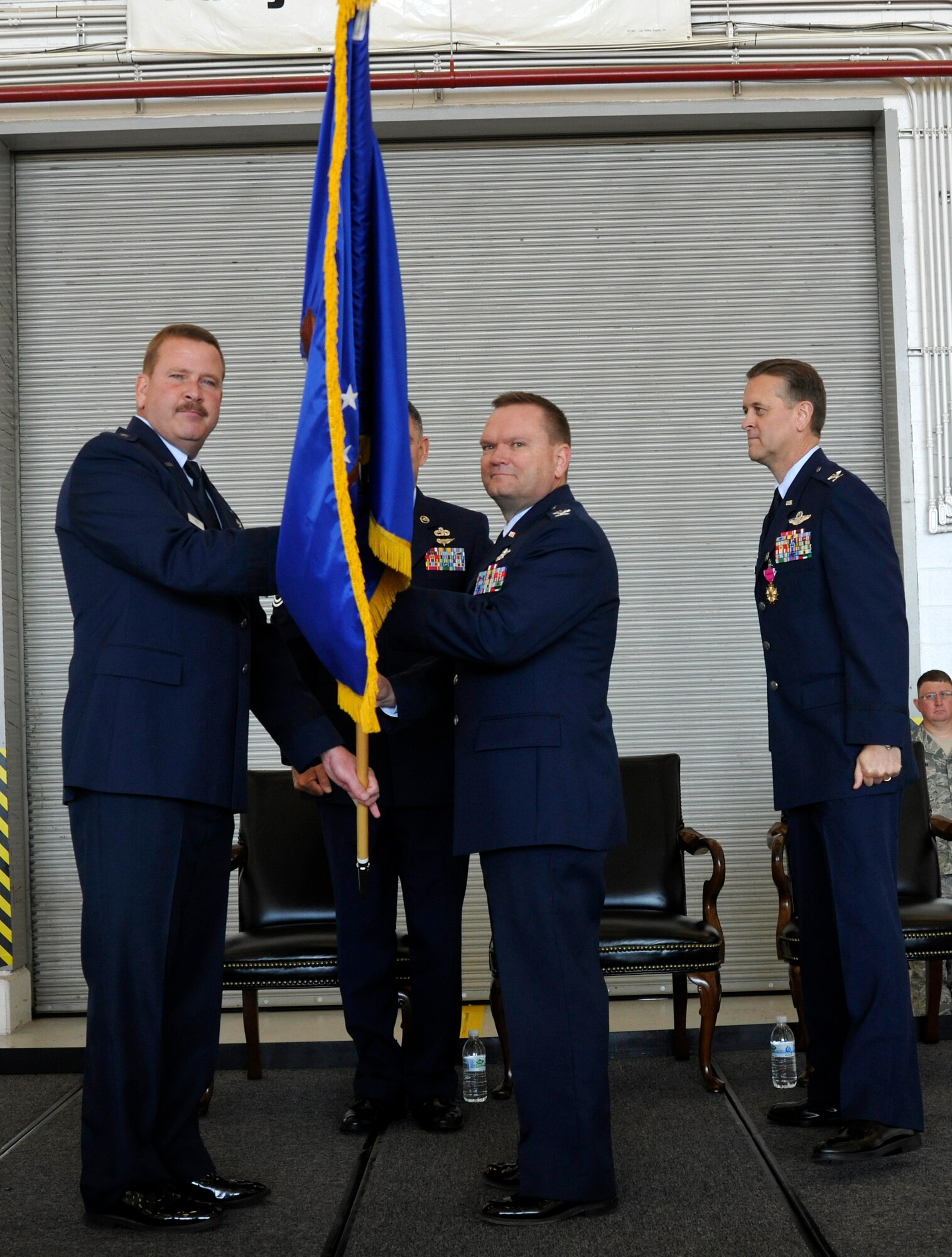 JOINT BASE ANDREWS, Md. -- Brigadier General Mark Kyle (left), 4th Air Force commander, passes the 459th Air Refueling Wing guidon to Col. Samuel Mahaney during a change of command ceremony here Oct. 15. Leadership of the 459th Air Refueling Wing has been passed to Colonel Mahaney, who comes to the wing from an operations group commander position at Westover Air Reserve Base, Mass. (U.S. Air Force photo/Airman First Class Lindsey Beadle)