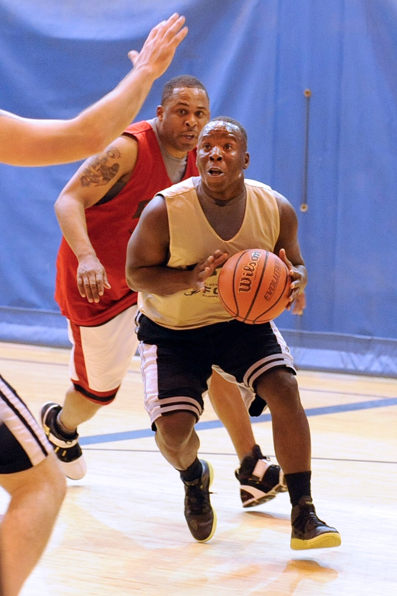 Intramural basketball action featuring 84th Engineer Support Company (gold jerseys) against Headquarters and Headquarters Company, 4th Brigade Combat Team (Airborne), 25th Infantry Division Oct. 17 at Buckner Physical Fitness Center. HHC/4-25th ABCT came from behind in the second half for a 48-43 victory. (U.S. Air Force photo/John Pennell)