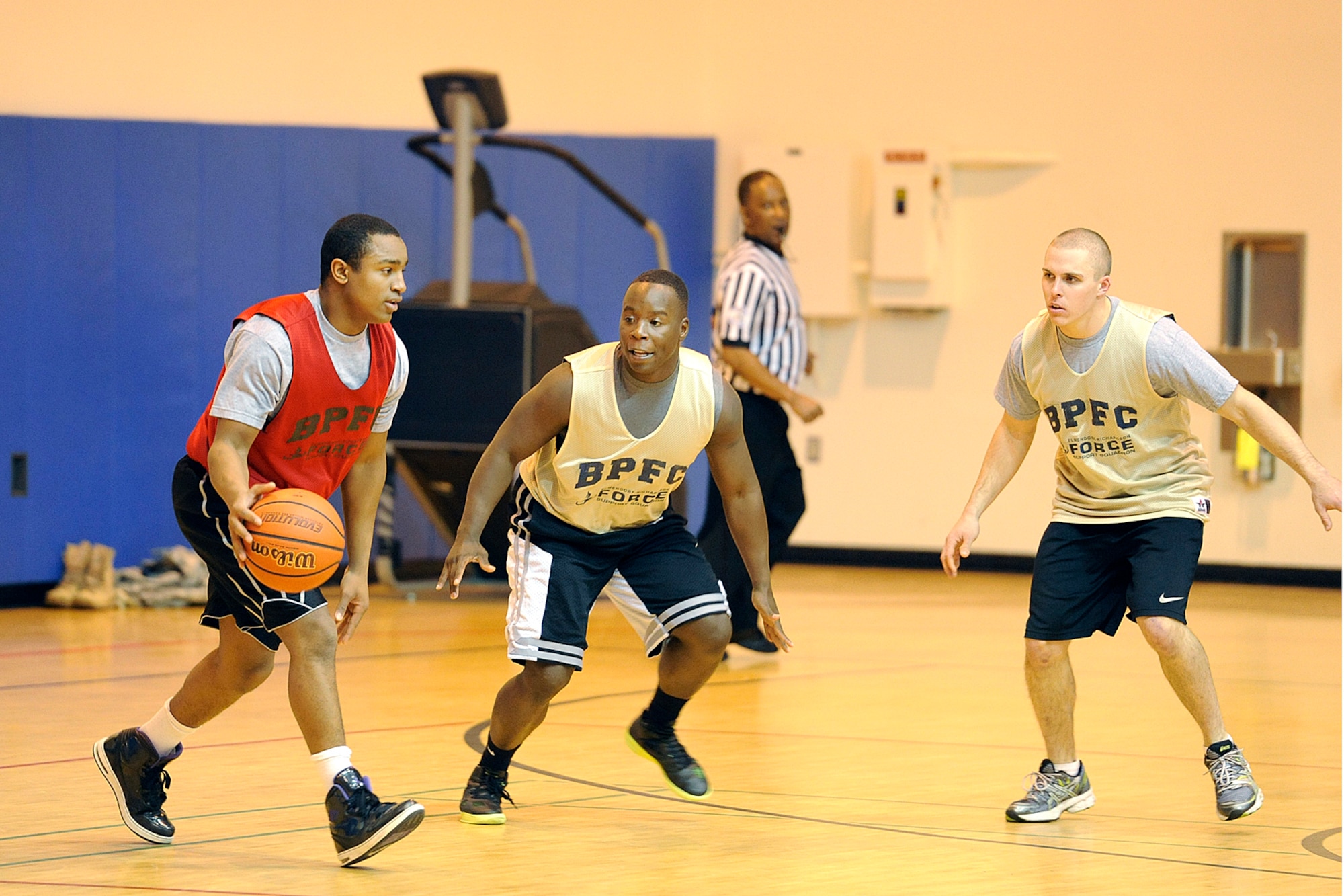 Intramural basketball action featuring 84th Engineer Support Company (gold jerseys) against Headquarters and Headquarters Company, 4th Brigade Combat Team (Airborne), 25th Infantry Division Oct. 17 at Buckner Physical Fitness Center. HHC/4-25th ABCT came from behind in the second half for a 48-43 victory. (U.S. Air Force photo/John Pennell)