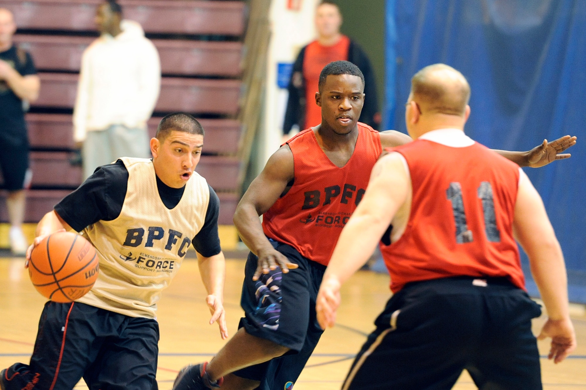 Paul Porras Jr. drives the ball upcourt against the Headquarters and Headquarters Company, 4th Brigade Combat Team (Airborne), 25th Infantry Division defense. Porras and his 84th Engineer Support Company teammates held a 23-21 edge at halftime, but lost the game 48-43. (U.S. Air Force photo/John Pennell)