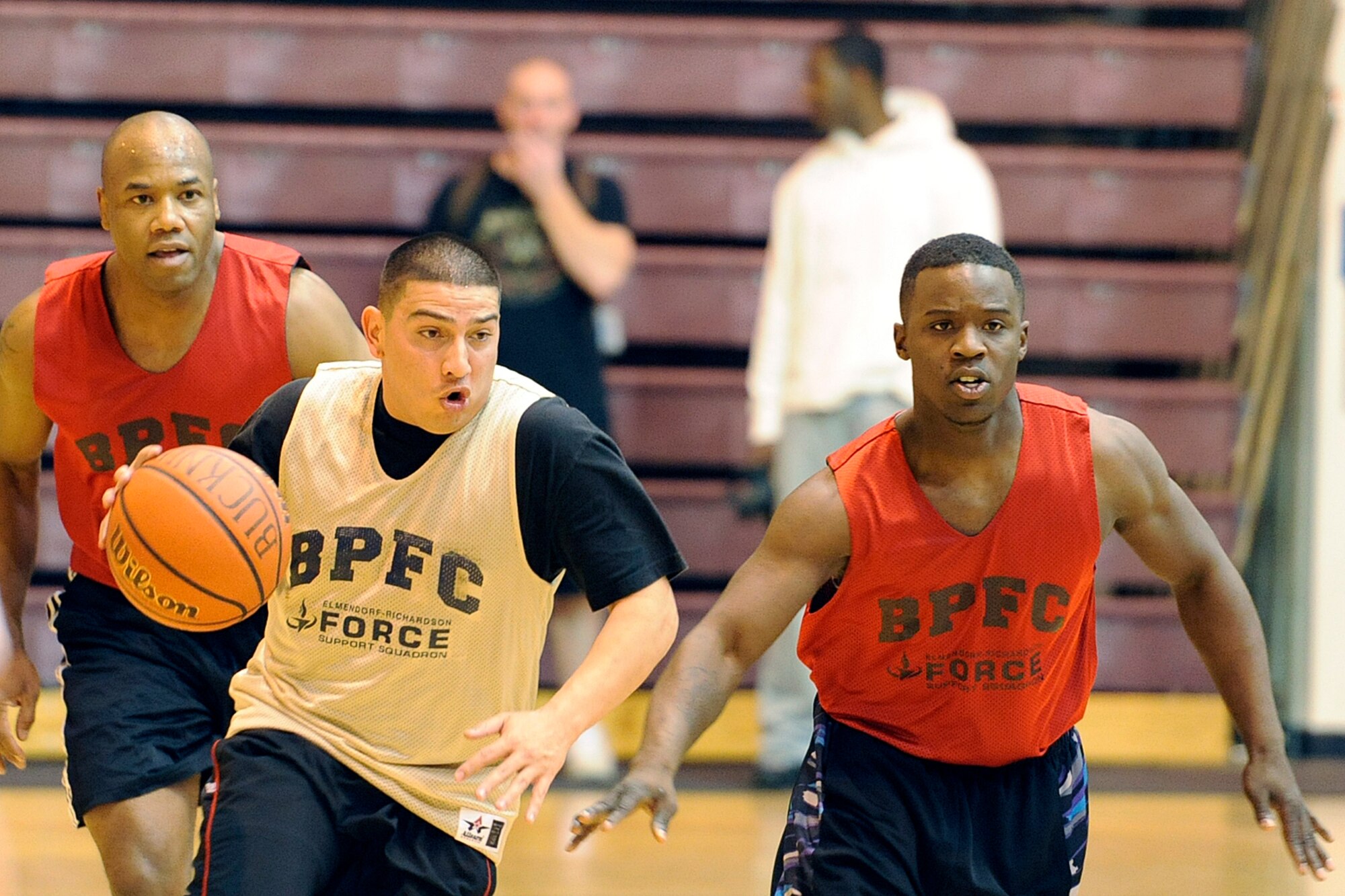 Paul Porras Jr. drives the ball upcourt against the Headquarters and Headquarters Company, 4th Brigade Combat Team (Airborne), 25th Infantry Division defense. Porras and his 84th Engineer Support Company teammates held a 23-21 edge at halftime, but lost the game 48-43. (U.S. Air Force photo/John Pennell)