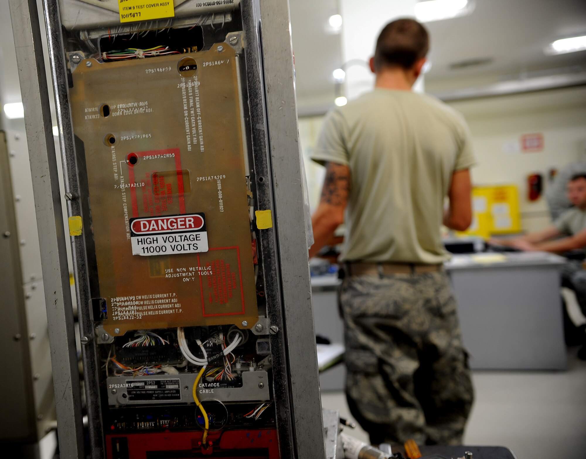 U.S. Air Force Airman 1st Class Zachary Byers, 18th Component Maintenance Squadron avionics intermediate shop technician, talks with U.S. Air Force Staff Sgt. Douglas Cummings, his section supervisor, about the frequency amplifier currently being repaired on Kadena Air Base, Japan, Oct. 18. The avionics flight provides support to all Kadena Air Base and visiting U.S. Air Force F-15 Eagle fighter jets. (U.S. Air Force photo/Staff Sgt. Christopher Hummel)