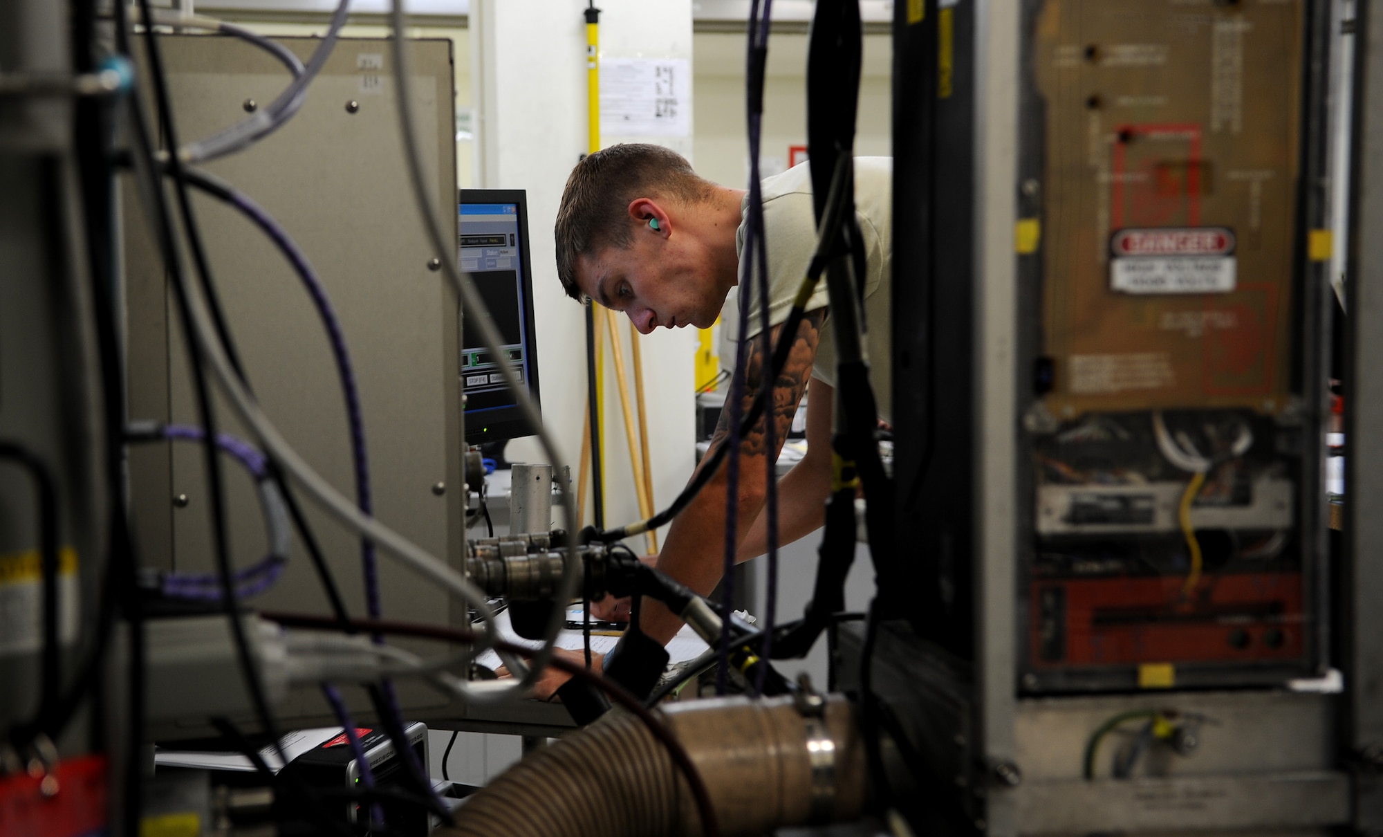 U.S. Air Force Airman 1st Class Zachary Byers, 18th Component Maintenance Squadron avionics intermediate shop technician, notes progress on the amplifier system he is maintaining on Kadena Air Base, Japan, Oct. 18. The avionics flight provides support to all Kadena Air Base and visiting U.S. Air Force F-15 Eagle fighter jets. (U.S. Air Force photo/Staff Sgt. Christopher Hummel)