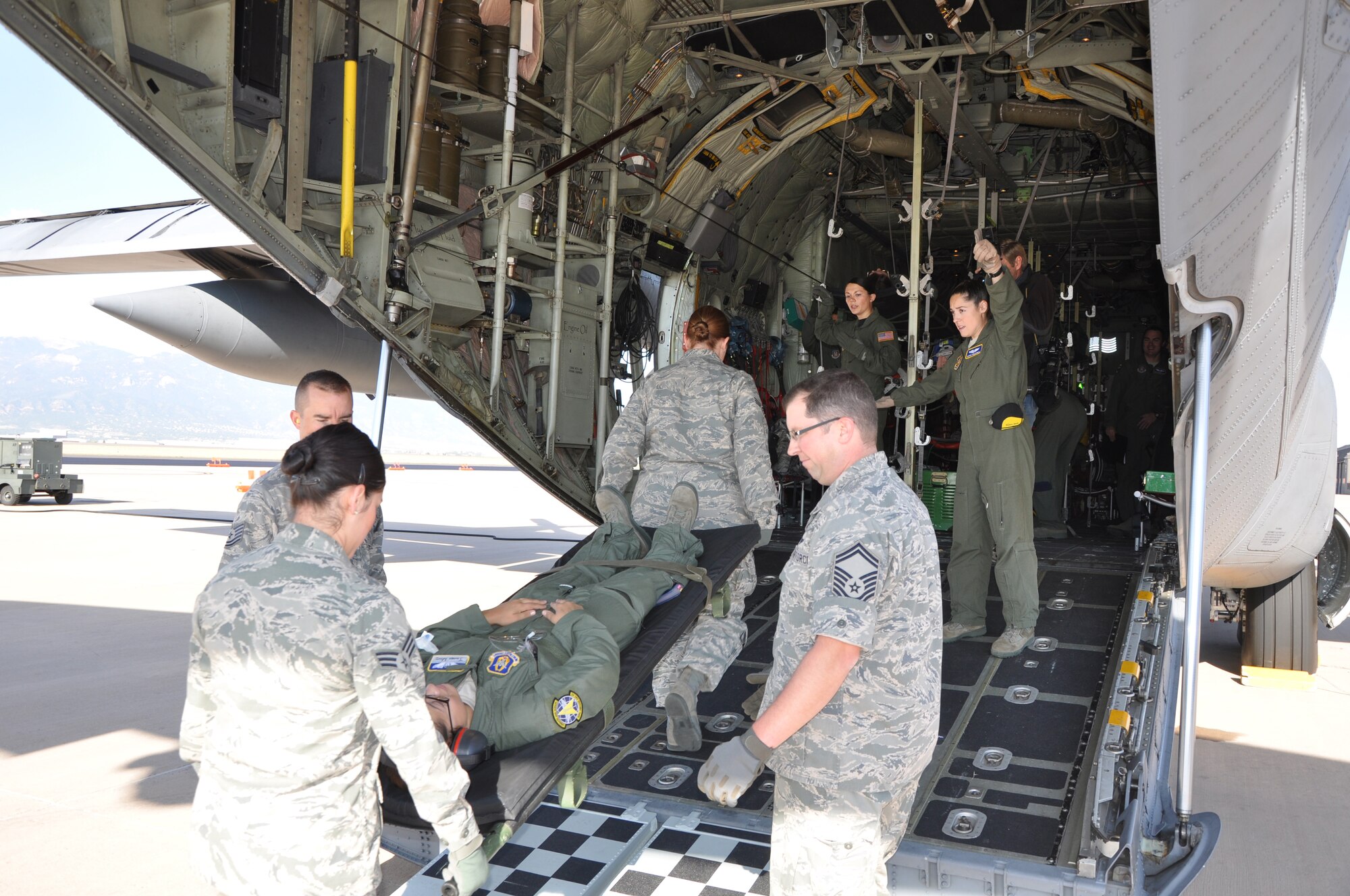 Medical professionals from the Air Force Reserve Command's 302nd Airlift Wing's Aeromedical Staging Squadron and the 34th Aeromedical Evacuation Squadron load a simulated patient onto a C-130 Oct. 3 during a routine aeromedical readiness training mission at Peterson Air Force Base, Colo. (U.S. Air Force photo/Tech. Sgt. Peter Dean)