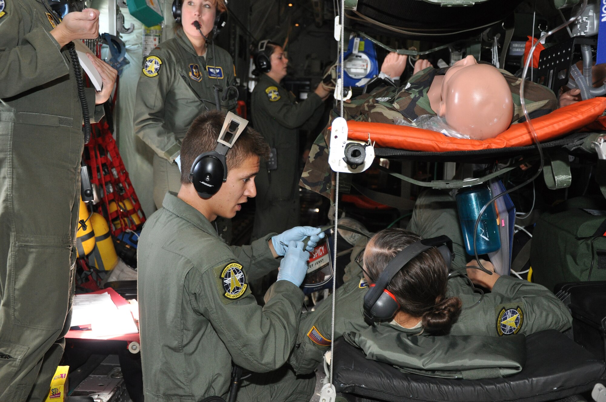 Senior Airman Chris Basham administers care to a simulated patient played by Senior Airman Karolyn Cichantek. Both are aeromedical technicians with the Air Force Reserve Command's 34th Aeromedical Evacuation Squadron. The two took part in a routine aeromedical readiness training mission that put their medical skills to the test on Oct. 3 at Peterson Air Force Base, Colo. (U.S. Air Force photo/Tech. Sgt. Peter Dean)