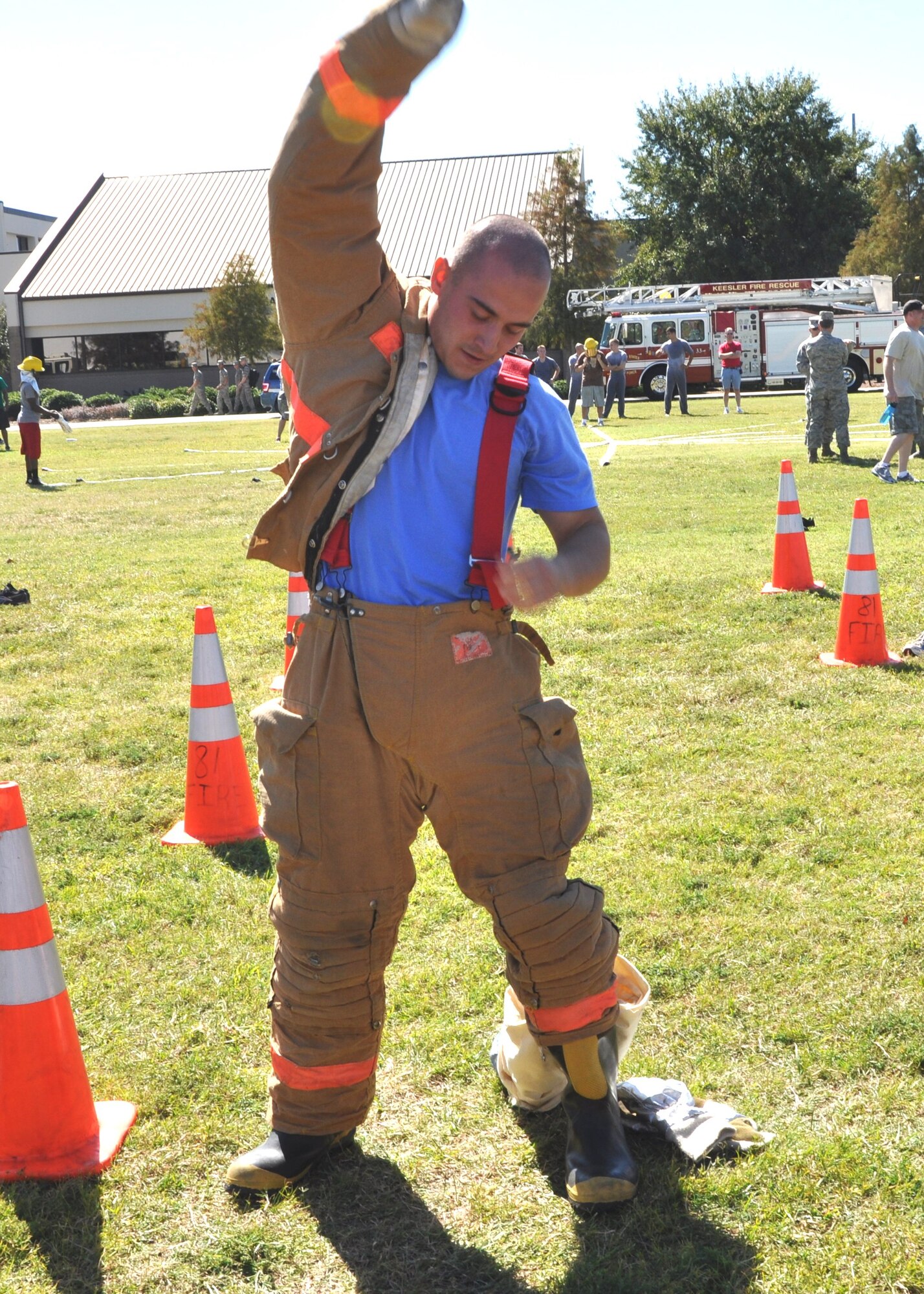 Airman 1st Class Aleksandar Petrakov dons bunker equipment during the “Bunker Drill” competition of the Oct. 14 Keesler Air Force Base, Miss., annual Fire Muster.  He is a member of the 81st Medical Operations Squadron “Dragon Medics” team.   The Fire Muster, sponsored by the Keesler Fire Department, was held in conjunction with Fire Prevention Week, Oct. 11-15, 2011.  (U.S. Air Force photo by Steve Pivnick)