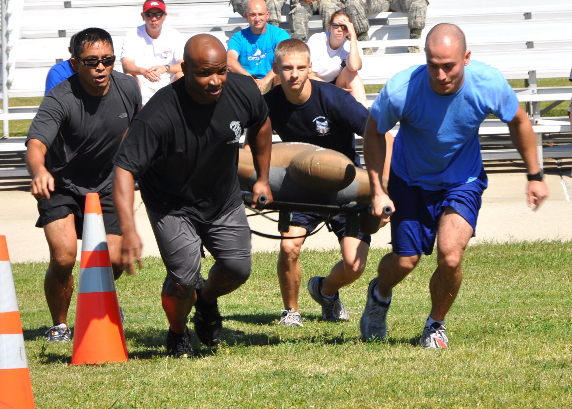From left, Master Sgt. Jerry Dameron, Tech Sgt. Jermain Smith, Senior Airman Christopher Foster and Airman 1st Class Aleksandar Petrakov carry “Randy” as they participate in the “Rescue Randy” event of the Oct. 14 Keesler Air Force Base, Miss., annual Fire Muster.  All are members of the 81st Medical Operations Squadron “Dragon Medics” team.   The Fire Muster, sponsored by the Keesler Fire Department, was held in conjunction with Fire Prevention Week, Oct. 11-15, 2011.  (U.S. Air Force photo by Steve Pivnick)