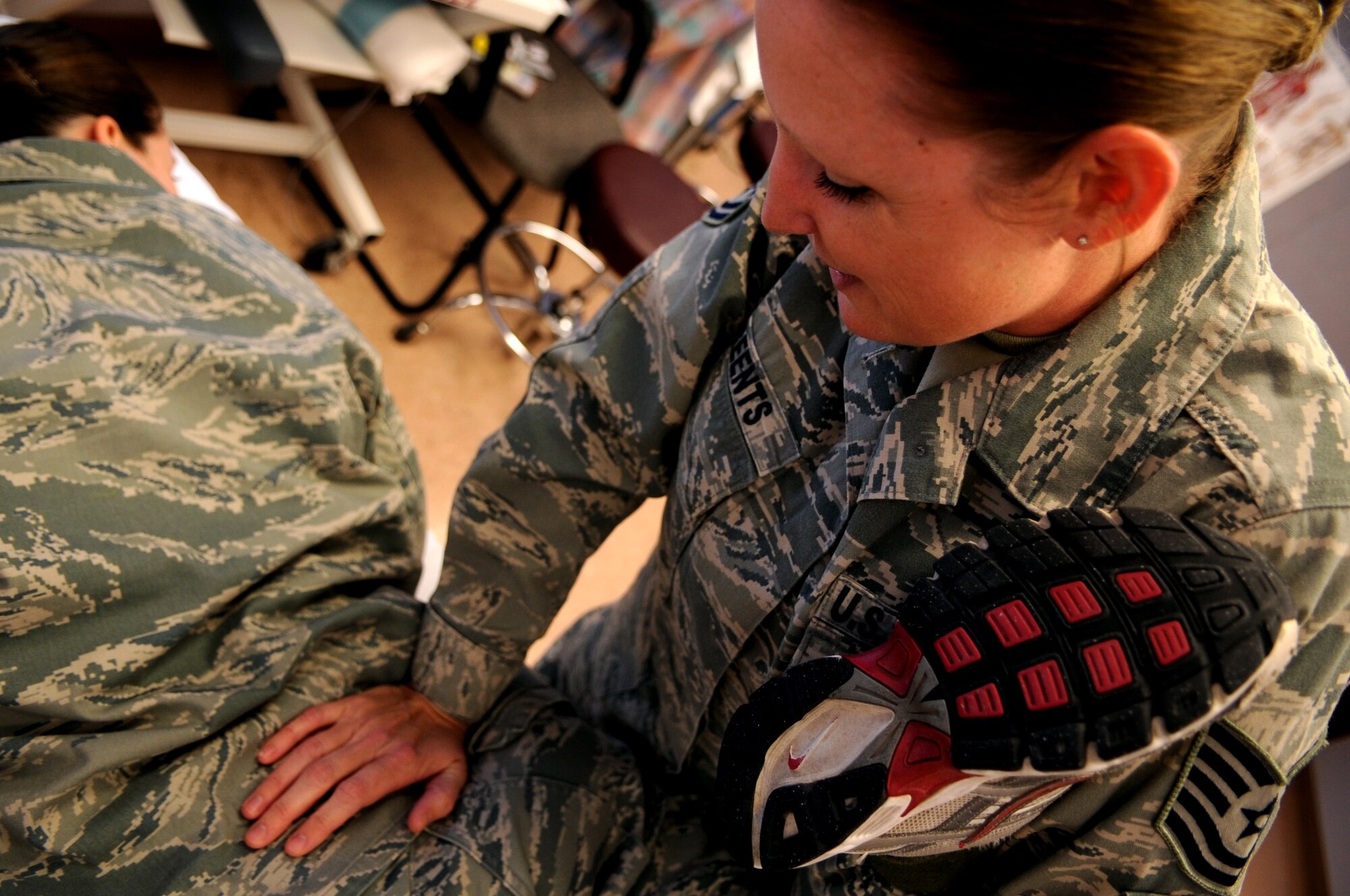 Tech. Sgt. Jamie Reents, 319th Medical Operations Squadron NCO in charge of physical therapy, stretches a patient out on Grand Forks Air Force Base, N.D., on Oct. 19. Sergeant Reents is the Warrior of the Week for October 20-27. (U.S. Air Force photo/Senior Airman Amanda N. Stencil)