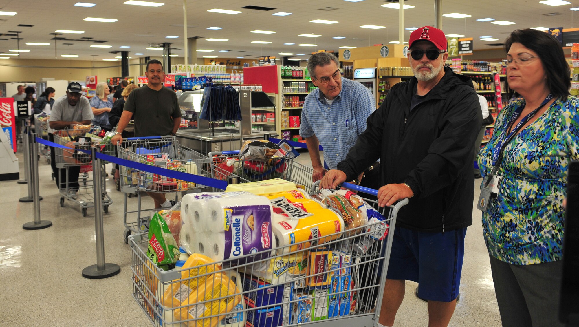Military members, spouses and retirees stand in the checkout line in the remodeled commissary at Moody Air Force Base, Ga., Oct. 19, 2011. The commissary opened their doors today after being closed for two days to prepare for the reopening.  During the reopening, prizes were given away to customers to include bikes, gift cards and professional football tickets. (U.S. Air Force photo by Staff Sgt. Stephanie Mancha/Released)